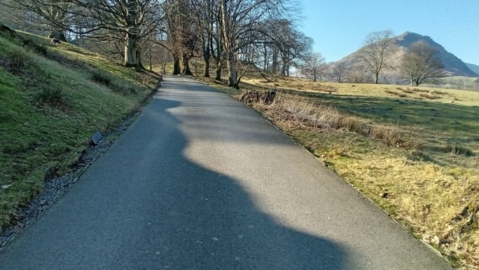 The uphill tarmac driveway to Allan Bank with a view of Helm Crag in the background, Allan Bank and Grasmere, Cumbria