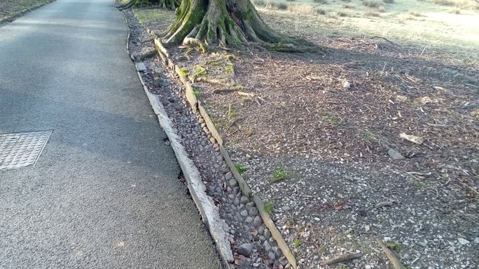 The old cobbled drains next to the tarmac driveway, Allan Bank and Grasmere, Cumbria