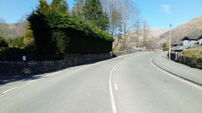 A main road lined with a green conifer hedge, Allan Bank and Grasmere, Cumbria