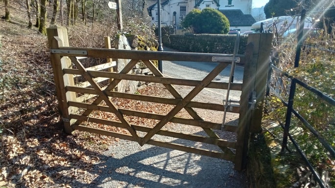 A large wooden gate opens inwards onto a road, Allan Bank and Grasmere, Cumbria