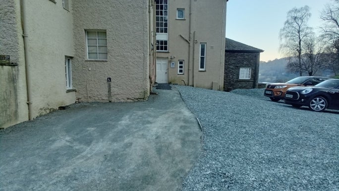 A fine compacted gravel path leading to Allan Bank next to a coarse gravel car park, Allan Bank and Grasmere, Cumbria