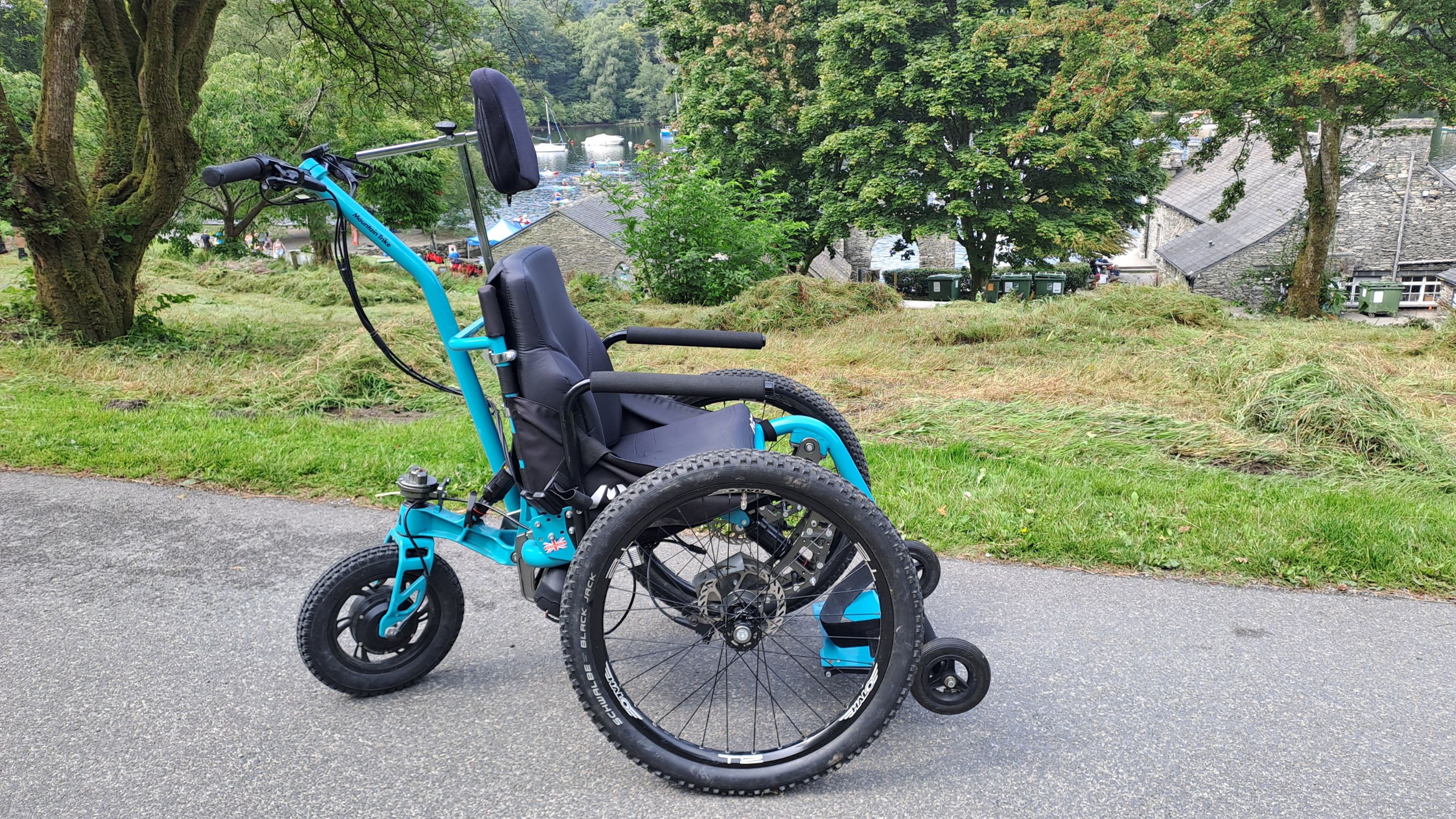 All-terrain wheelchair available for free hire at Fell Foot park, shown on a paved path with grassy surroundings and trees in the background.
