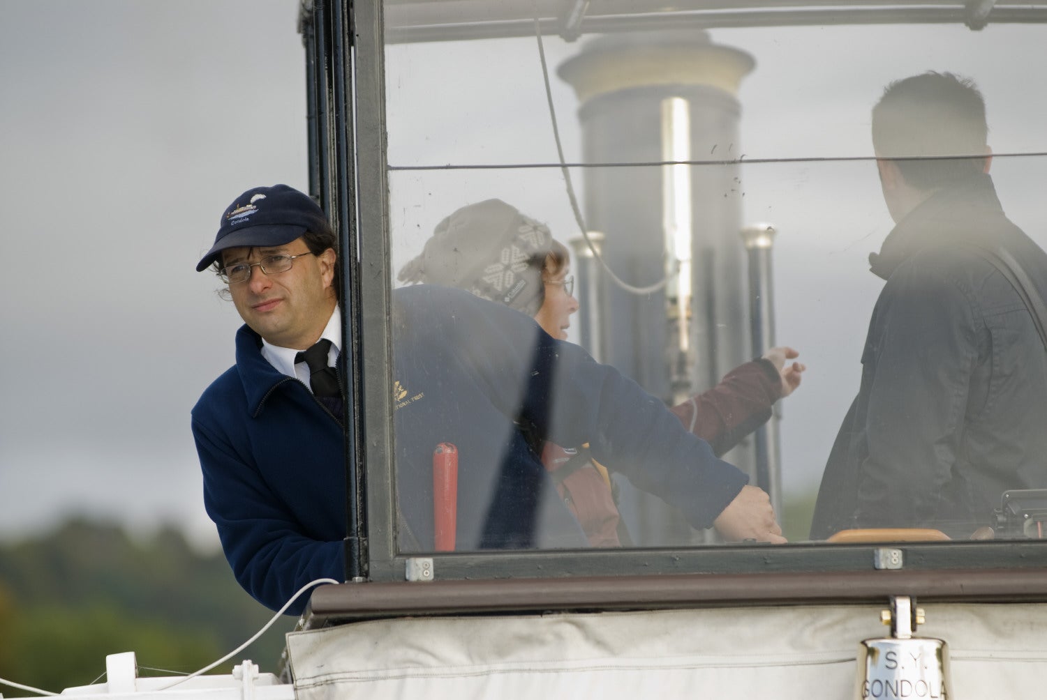 Crew member at the wheel of Gondola on Coniston