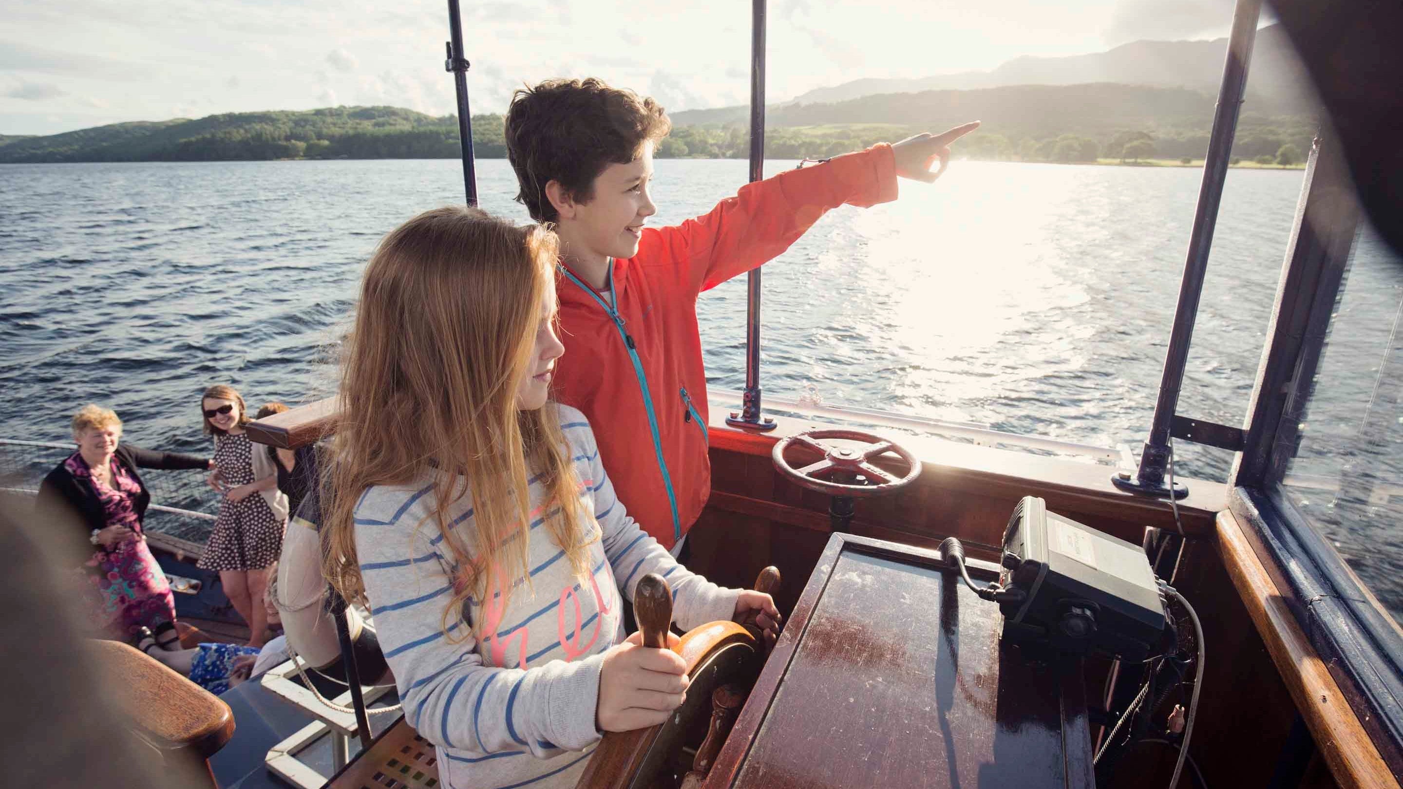 Passengers aboard the Gondola, a rebuilt Victorian steam-powered yacht, on Coniston Water