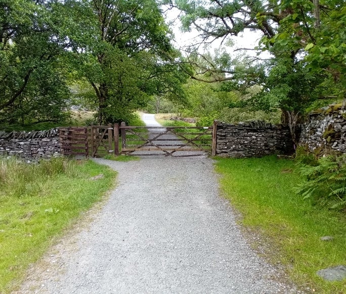 A footpath with a large wooden gate and grass either side of it, Tilberthwaite, Cumbria