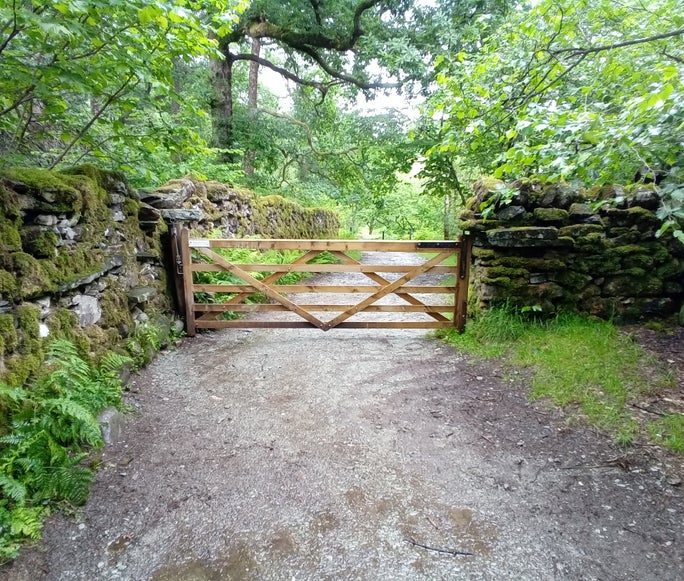 A large wooden gate across the footpath with drystone walls on both sides, Tilberthwaite, Cumbria