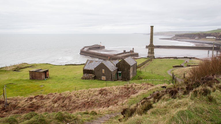 A view from the cliffs on the Whitehaven Coast, looking towards the Candlestick monument and the harbour.