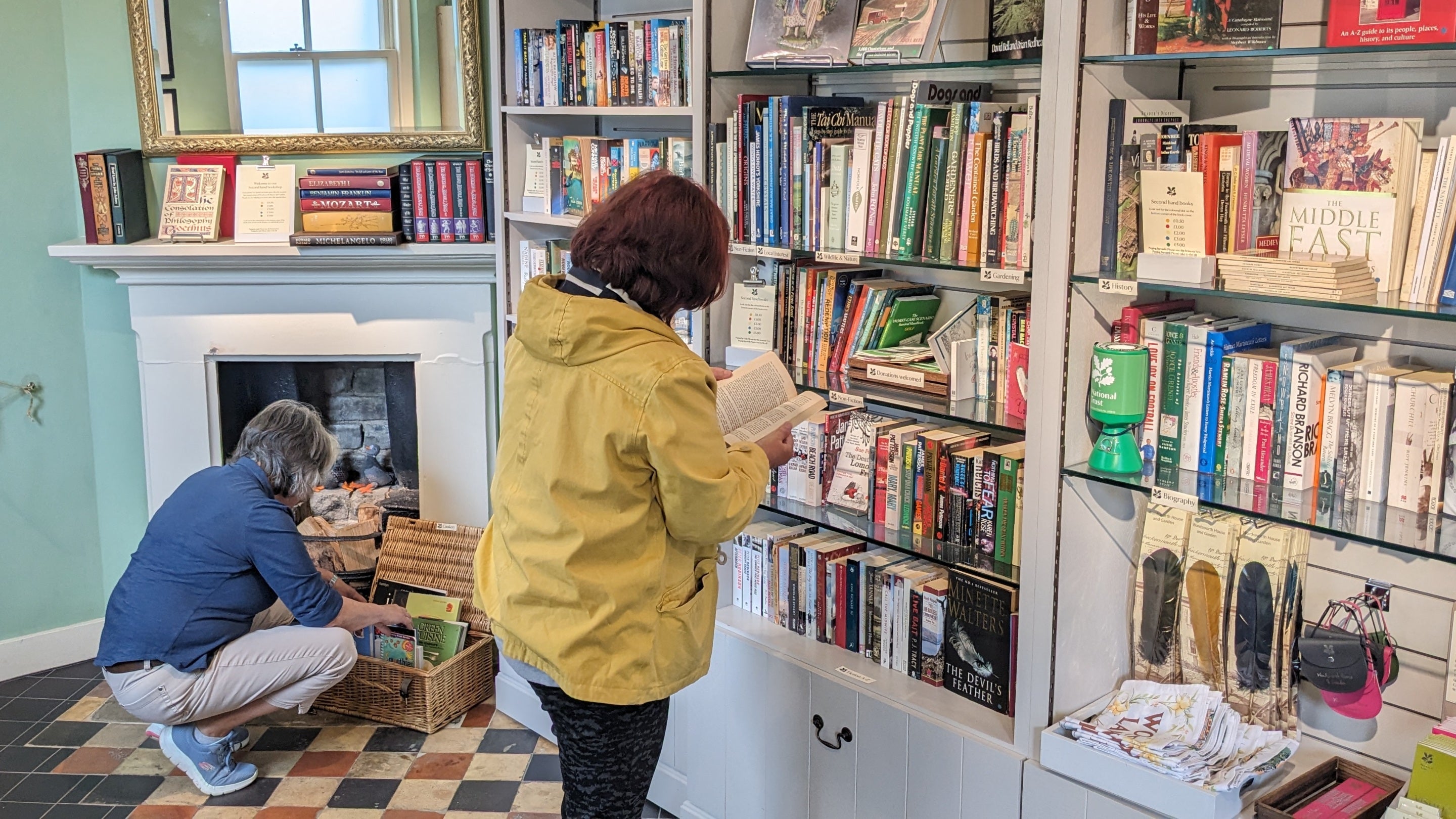 Two visitors browse the shelves of the second hand bookshop at Wordsworth House