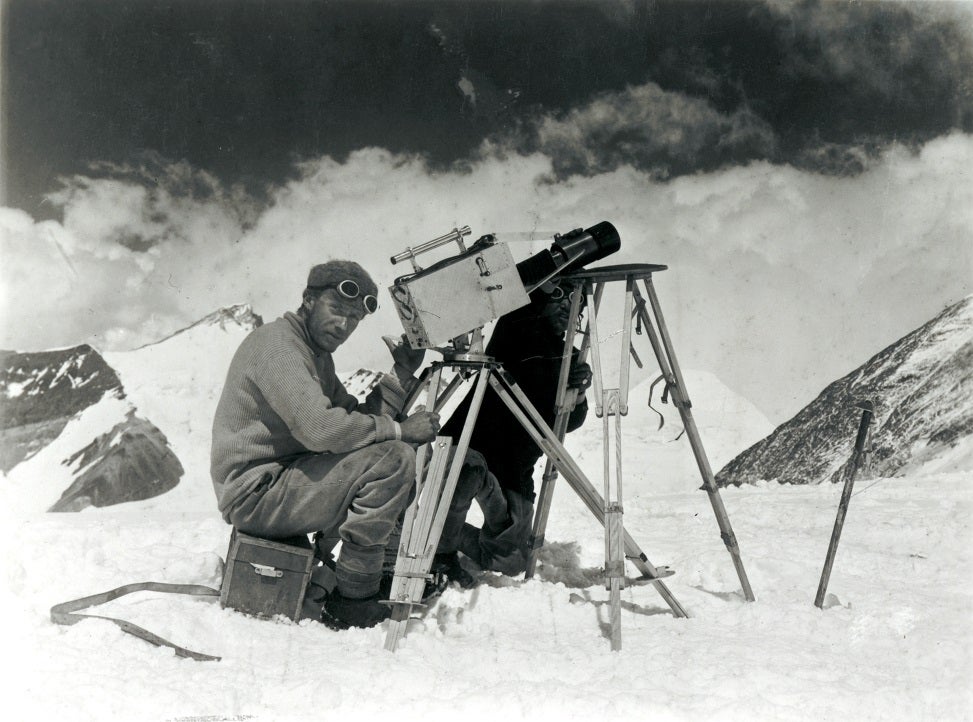 Black and white photo showing Captain Noel kinematographing the ascent of Mt. Everest from the Chang La ©Royal Geographical Society with IBG