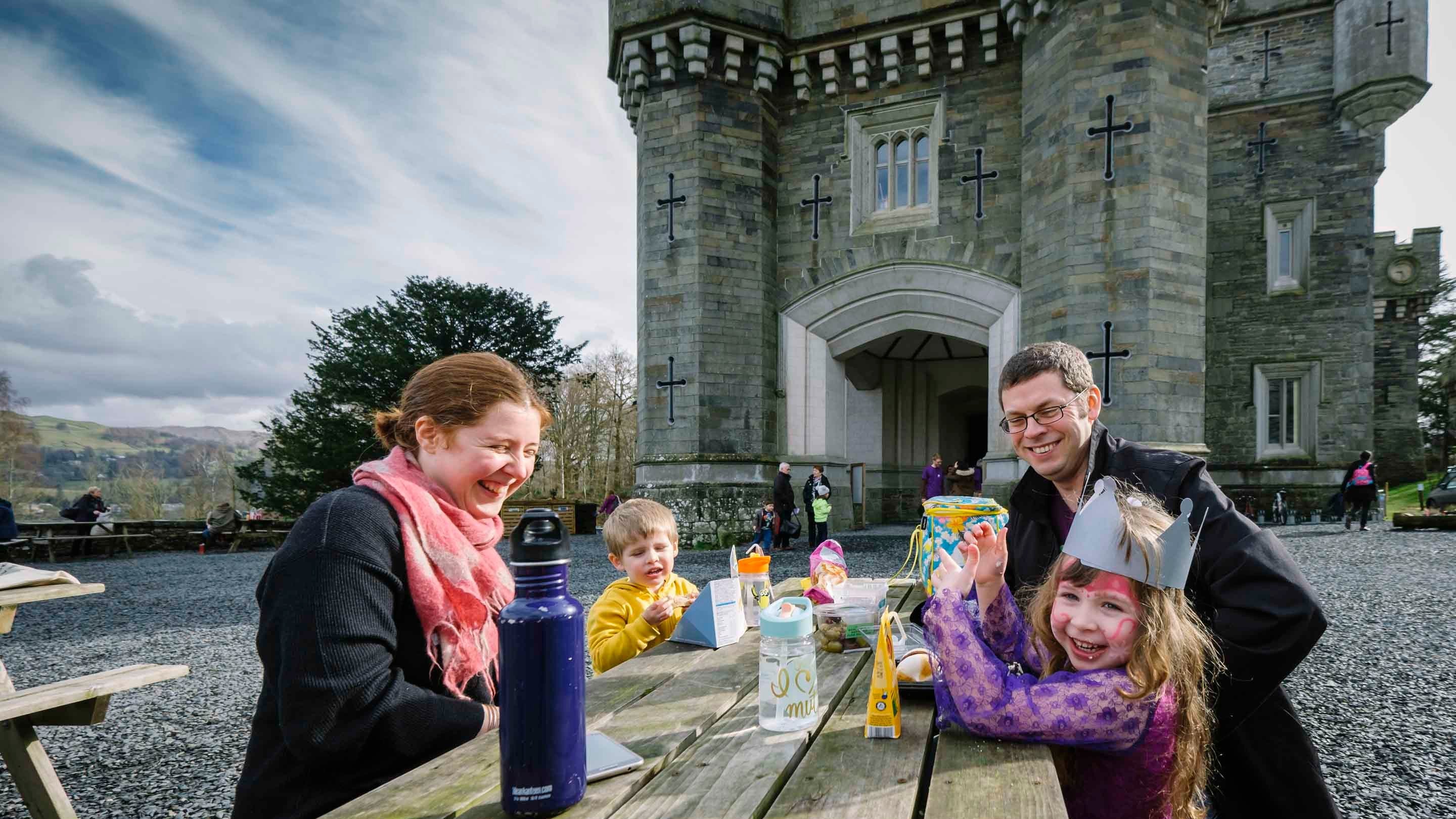 A family picnicking at Wray Castle, Cumbria