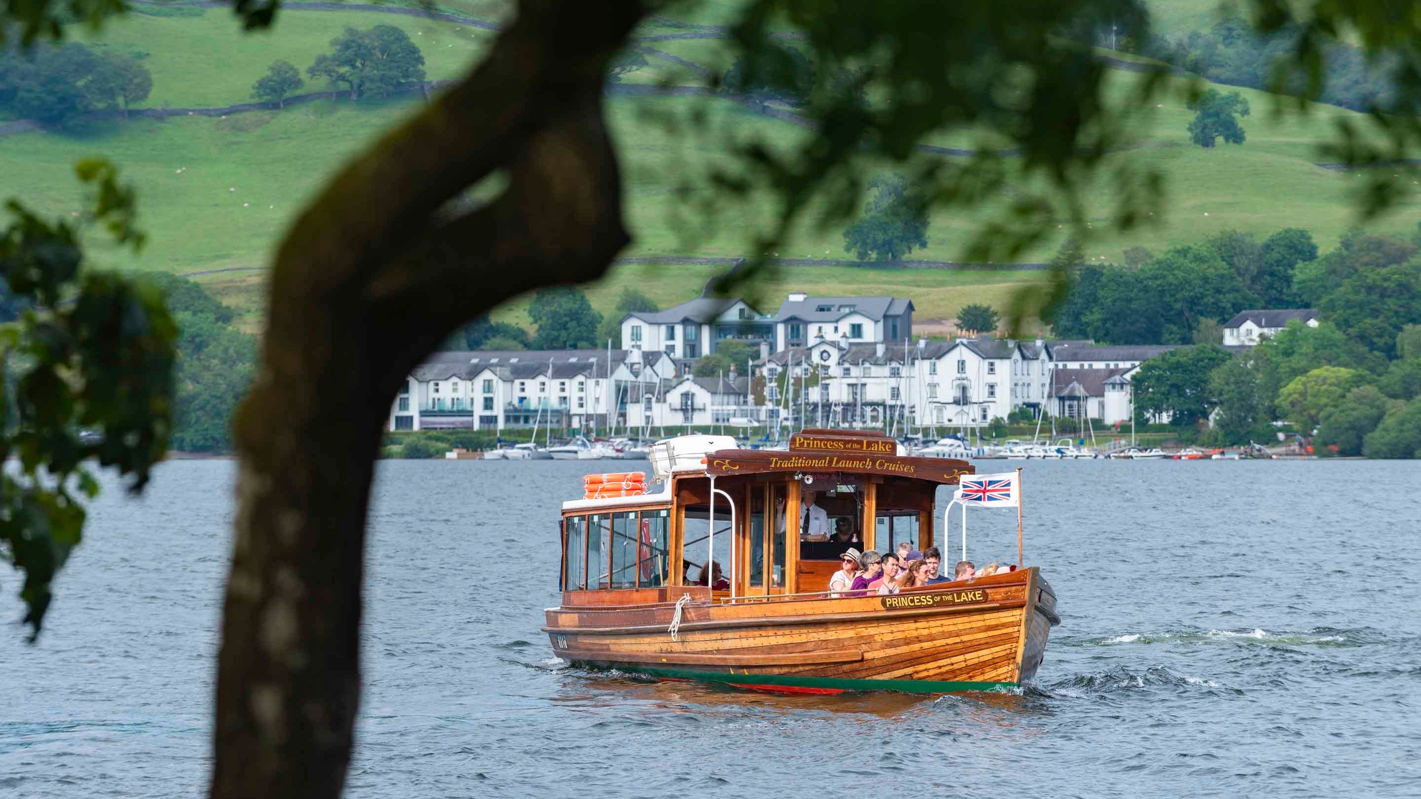 Visitors arriving by boat to Wray Castle in Ambleside, Cumbria, beside Lake Windermere