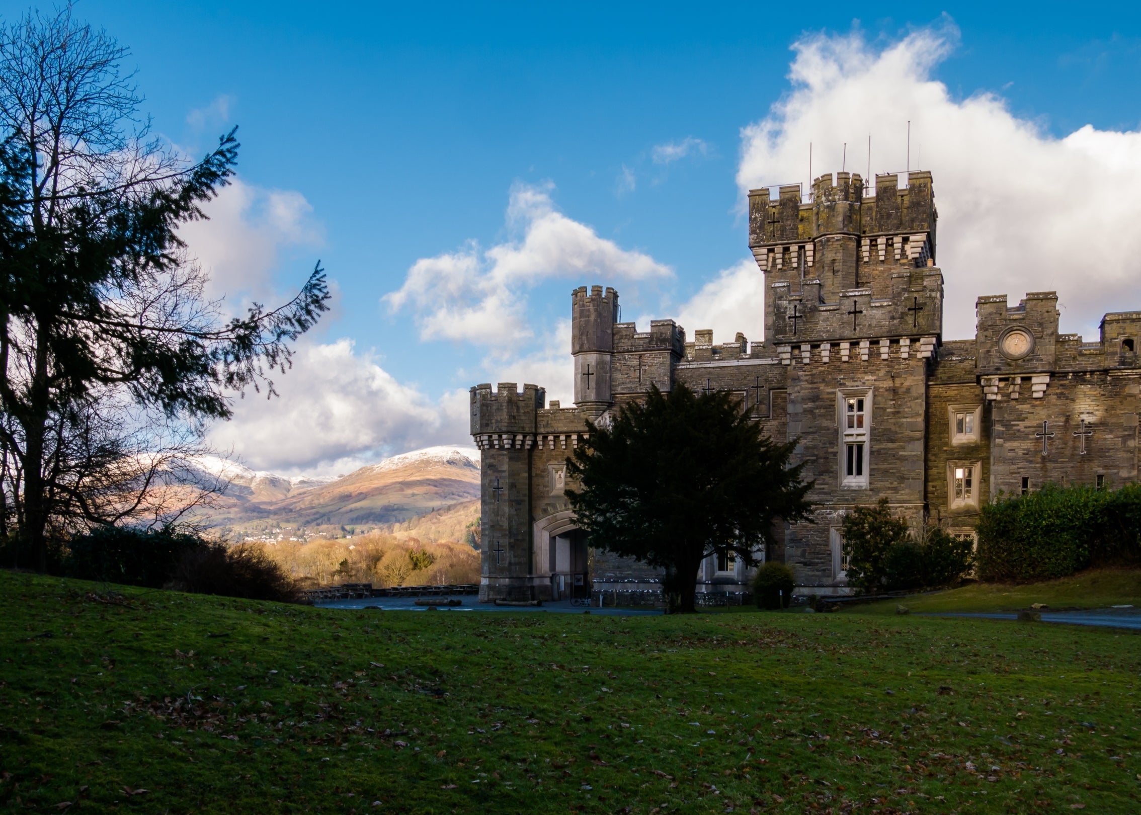 External view of Wray Castle Cumbria, in winter with snow on the fells in the distance.