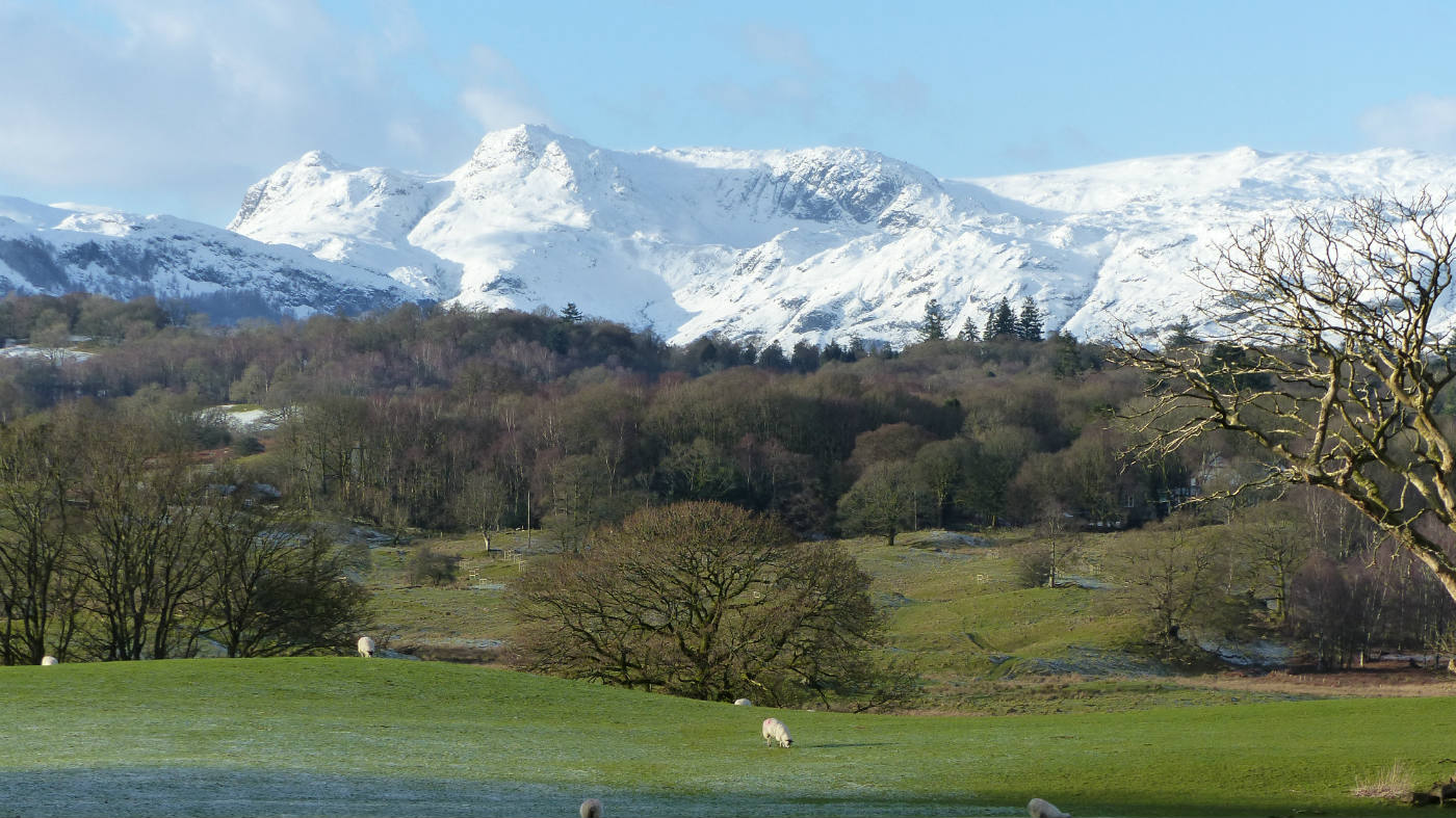 View of the snow capped mountain peaks of the Langdales taken in the grounds of  Wray, Cumbria