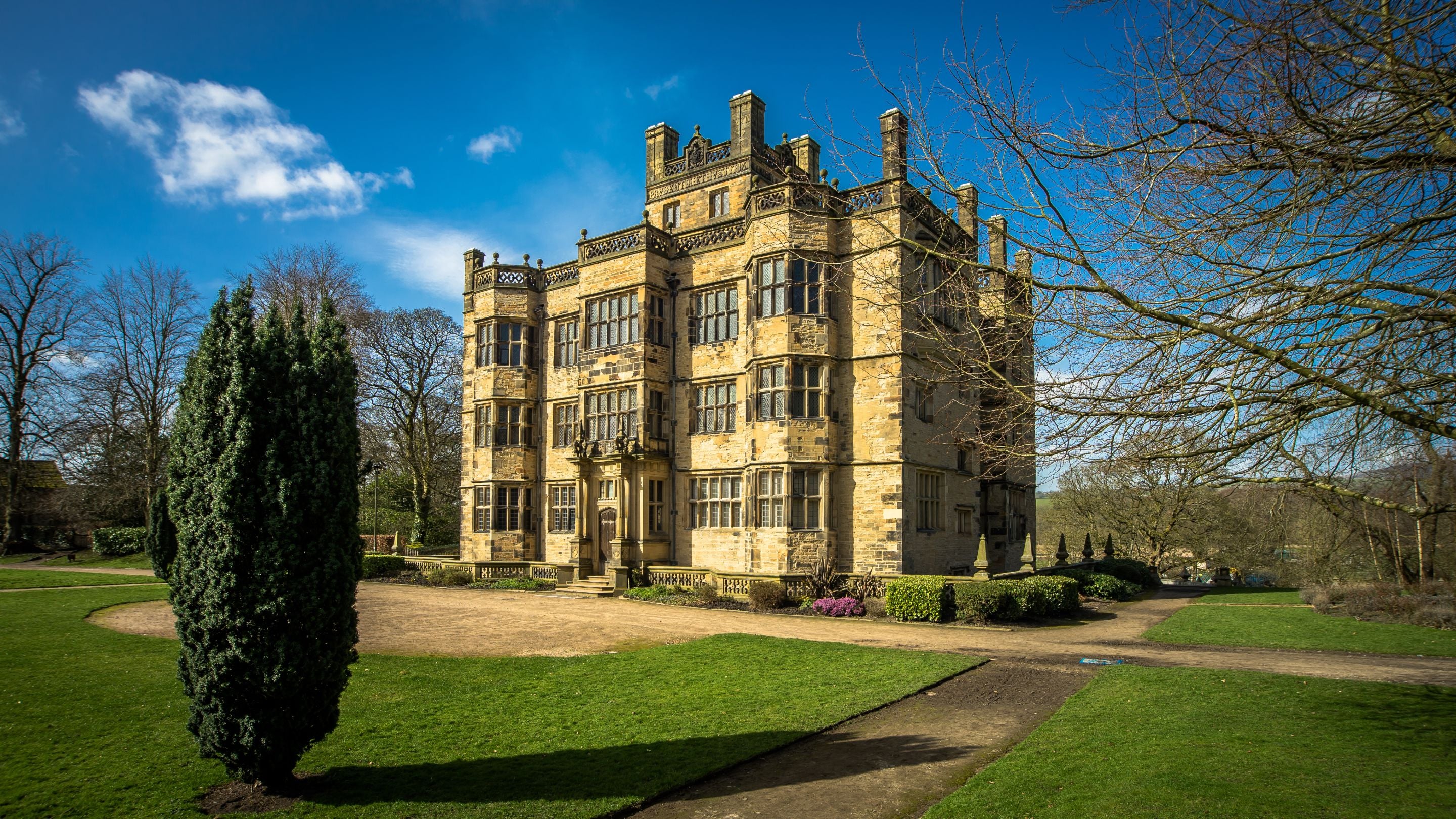 A view of the Gawthorpe Hall on a bright spring day