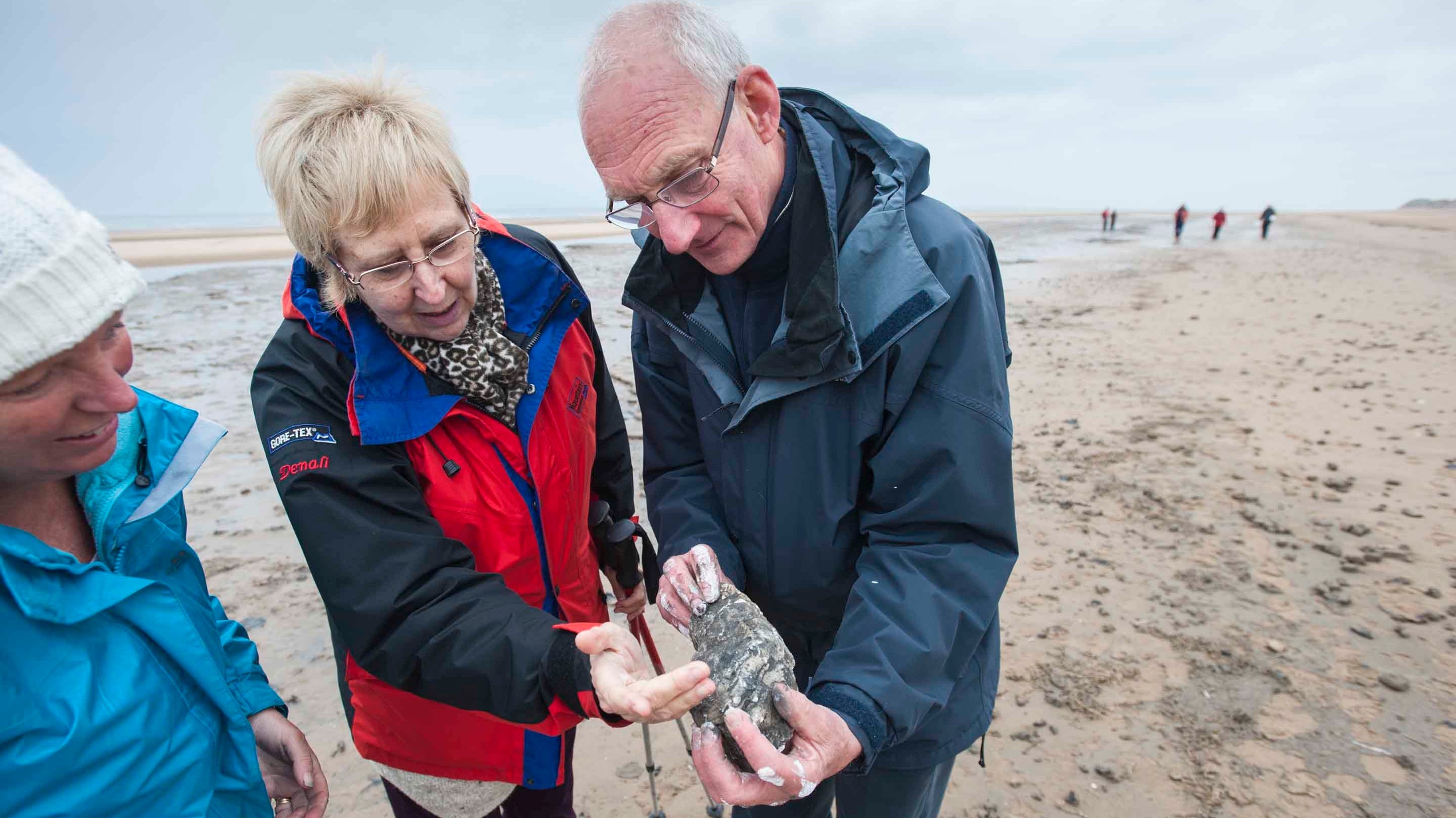 Visitors learning about the ancient footprints found on the shoreline at Formby, Merseyside.