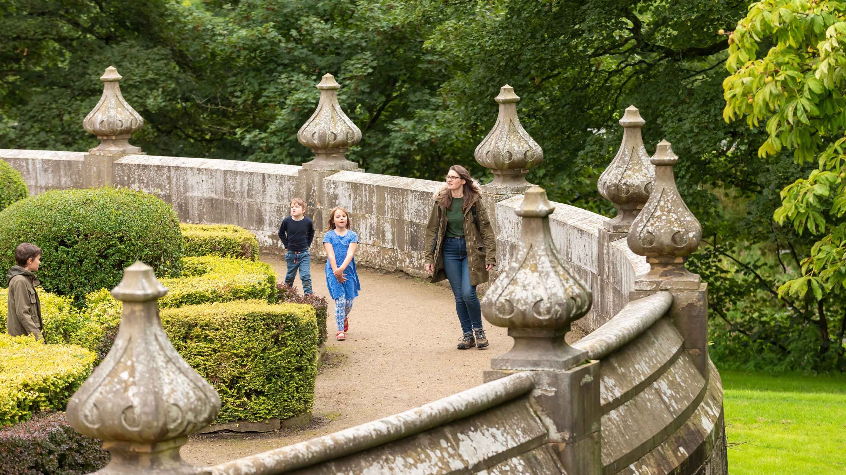 A family exploring the North Parterre at Gawthorpe Hall, Lancashire