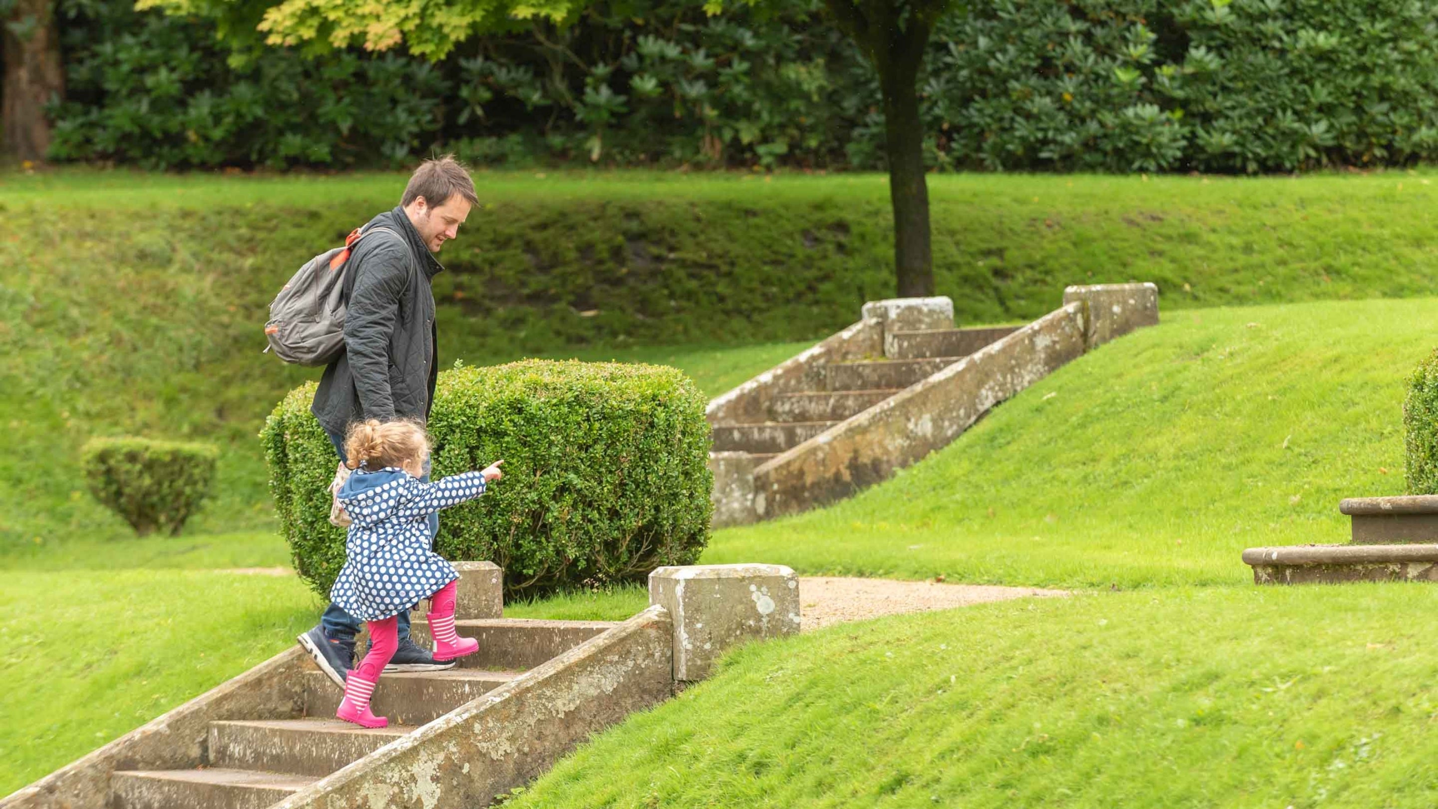 Visitors climbing steps in the south garden at Gawthorpe Hall, Lancashire in summer