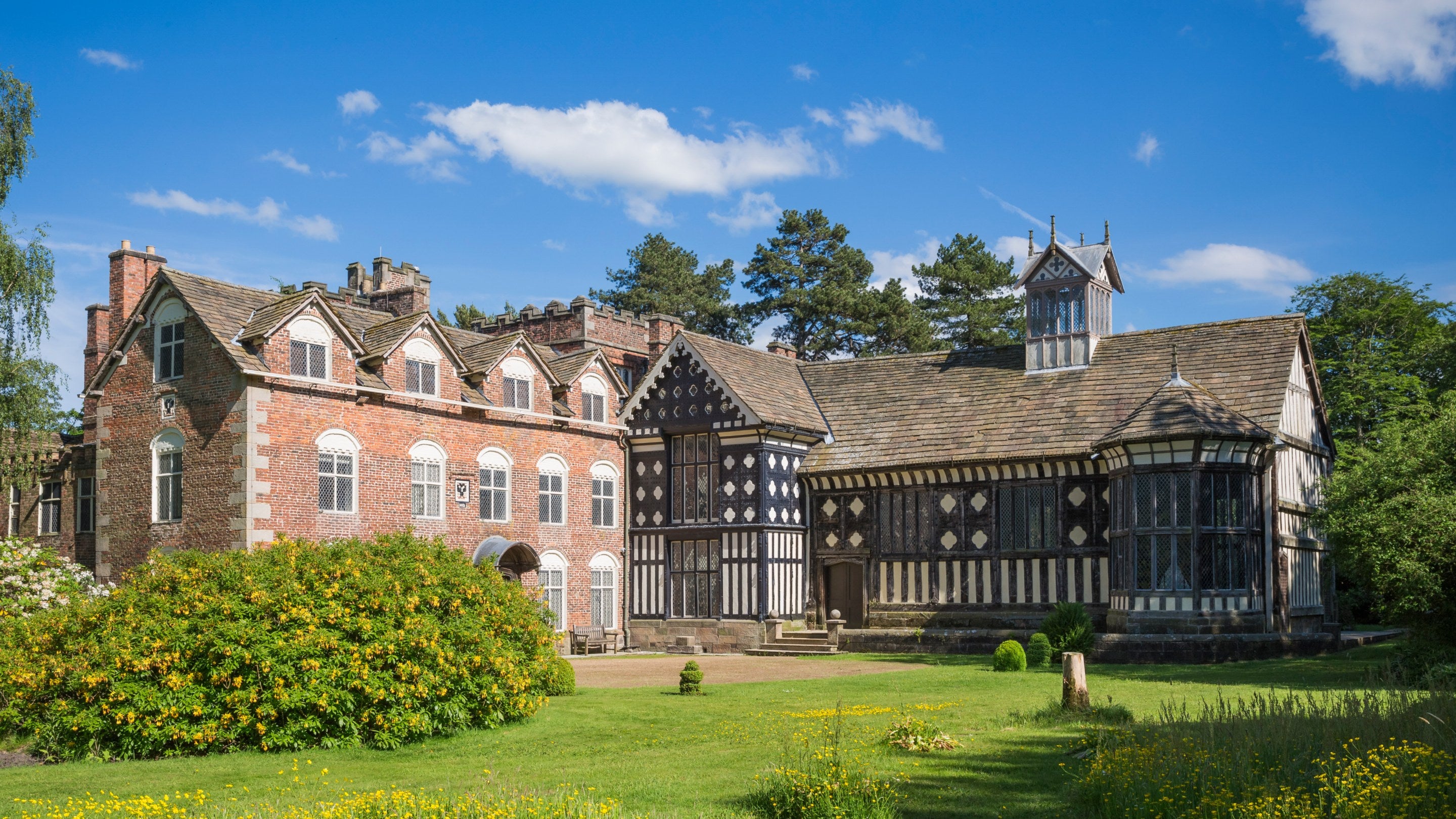 The house and garden in June at Rufford Old Hall, Lancashire, showing the beautiful Tudor building surrounded by Victorian and Edwardian gardens.