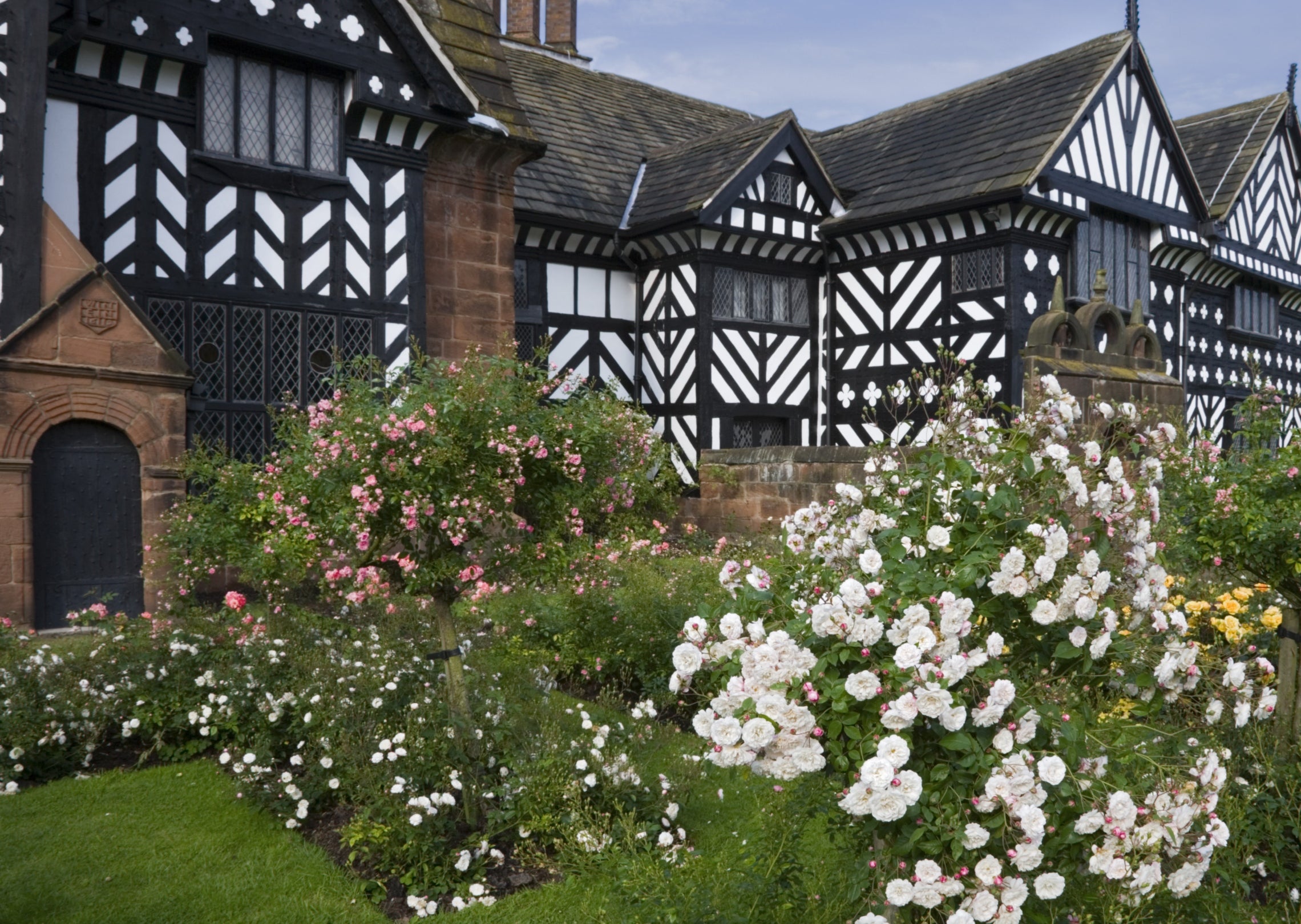 The South Range of the house with black & white timberwork at Speke Hall, Merseyside. The Rose garden is in the foreground.