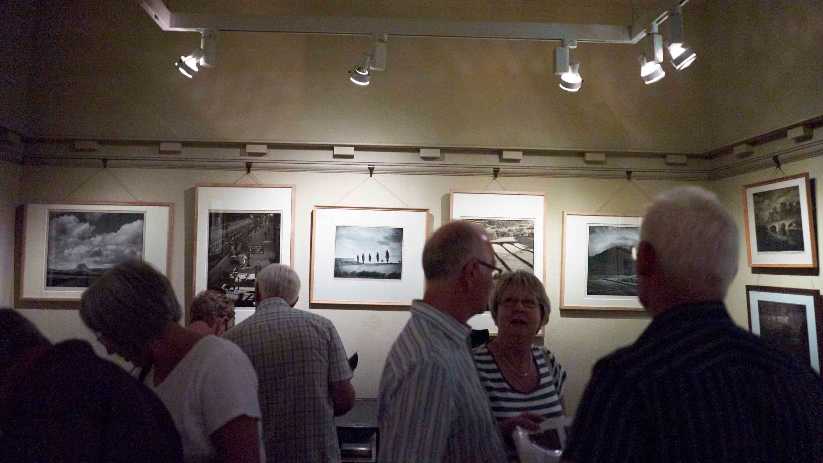 Visitors looking at prints at the Hardmans' House, Liverpool
