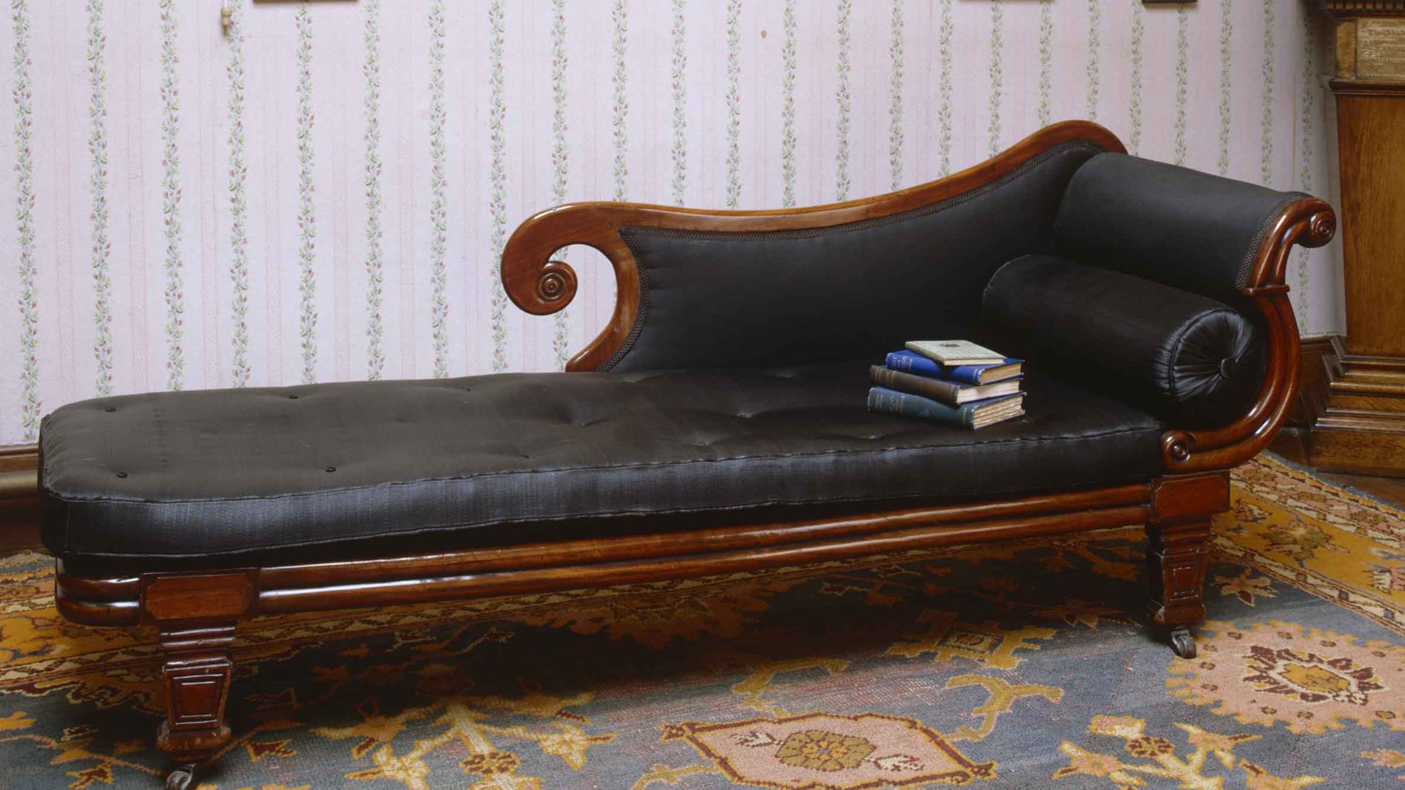 Day bed with a small pile of books on it, in the attic at Carlyle's House