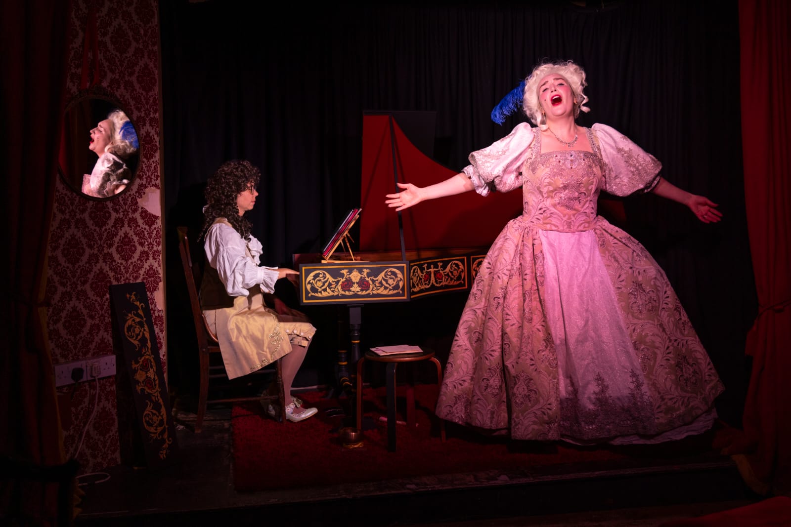 Performer as Marie Antoinette singing with the accompaniment of a keyboard player