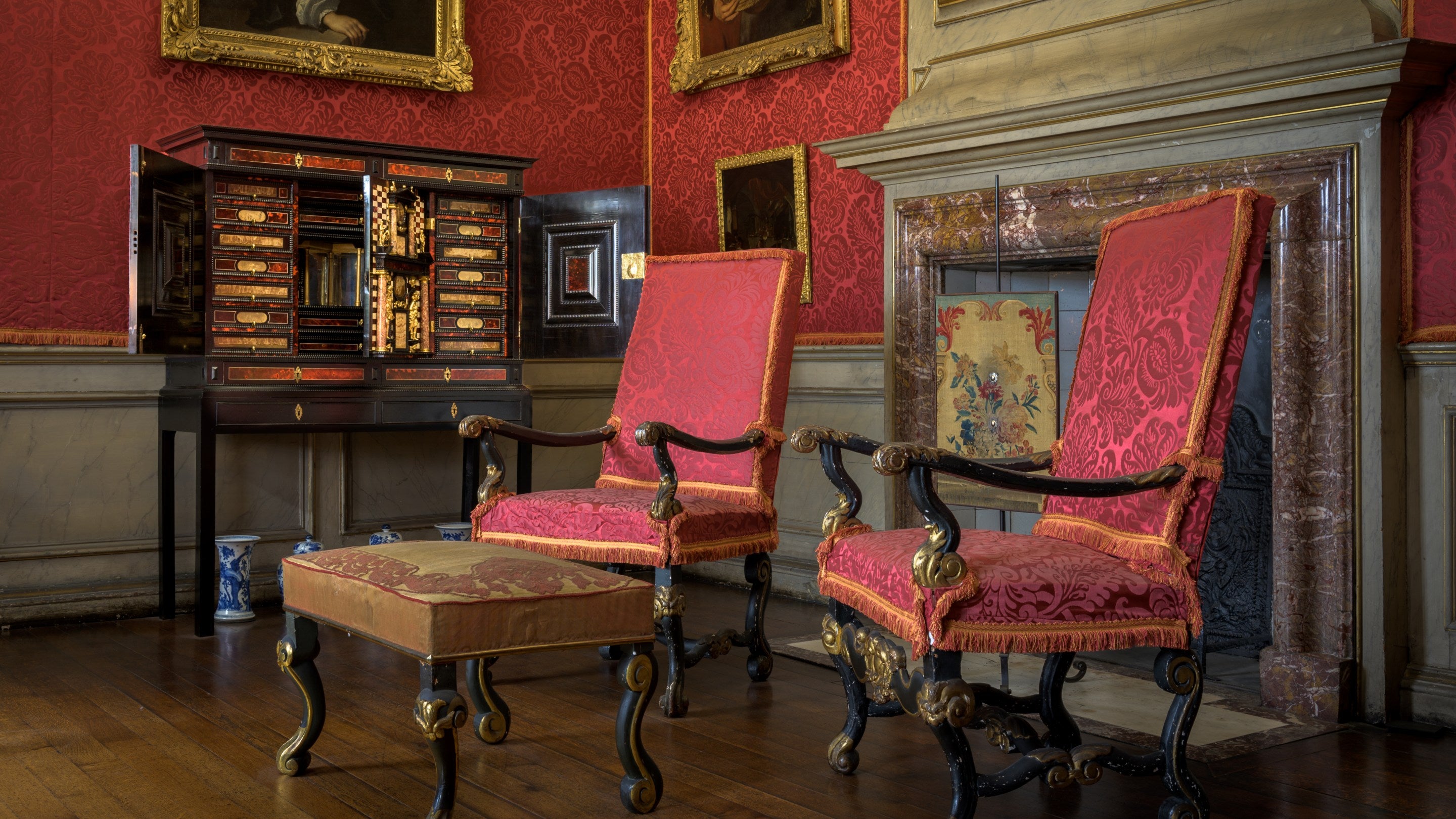 Antwerp cabinet in the withdrawing room at Ham House and Garden in London, with two chairs in the foreground