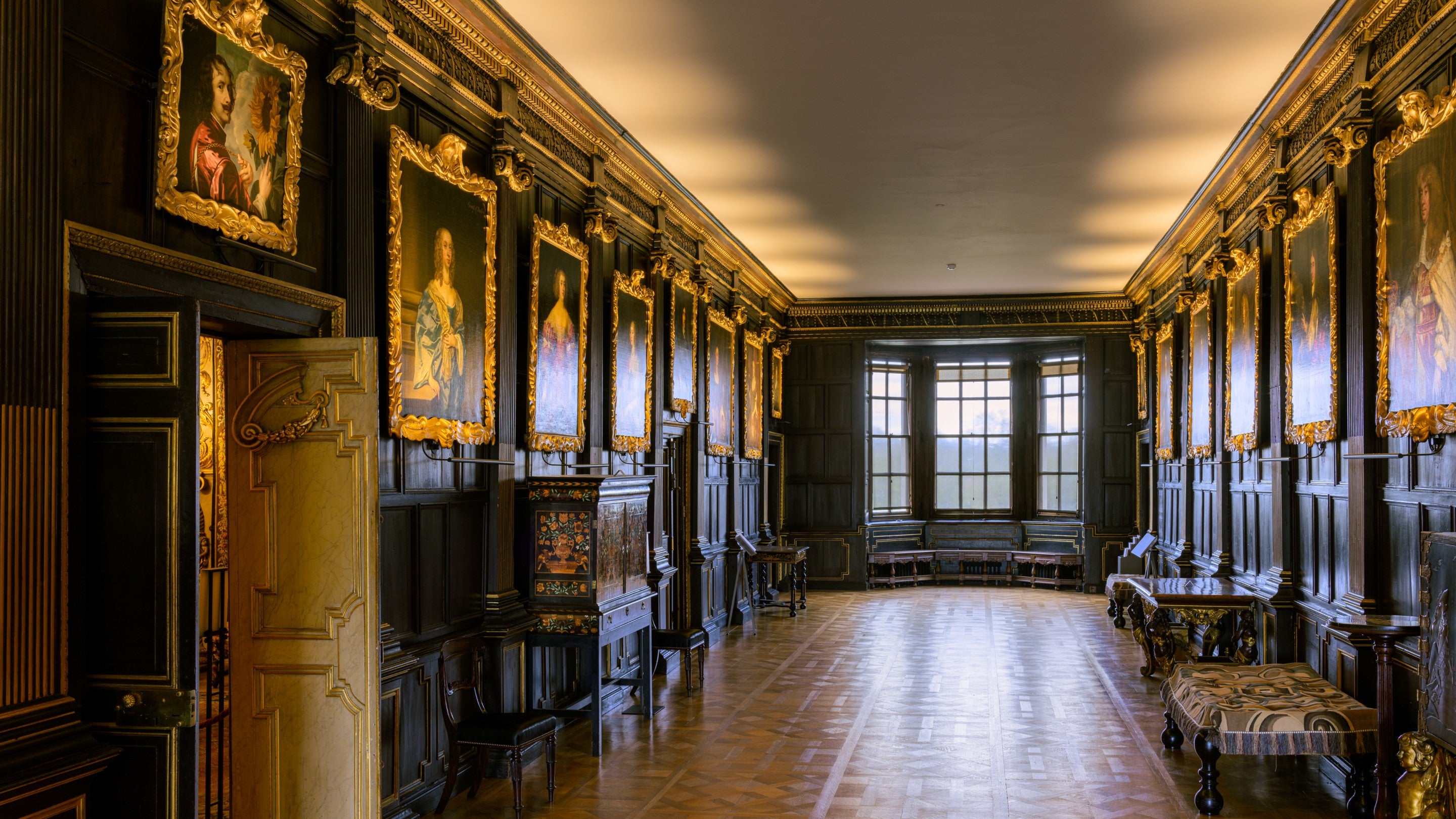 New lighting positioned over a series of portraits in the Long Gallery with a pale ceiling at Ham House and Garden, London