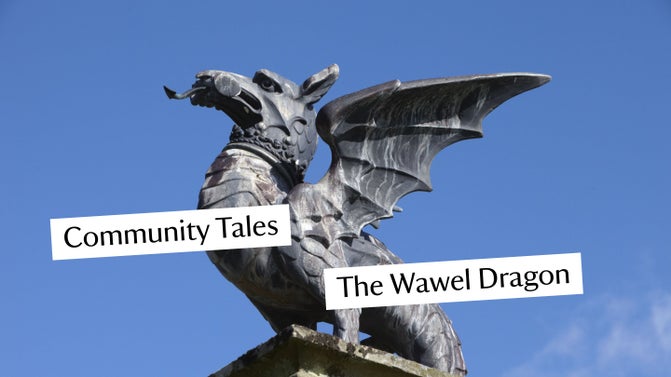 A close up image of a dragon statue against a blue sky
