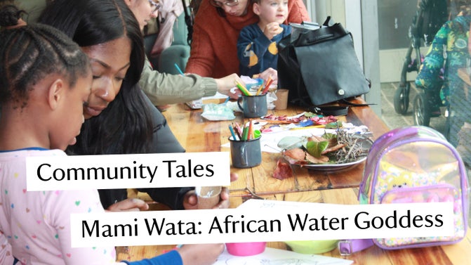 Parents and children gathered around a table participating in craft activities