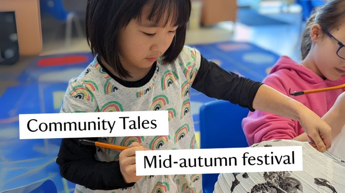 A young girl decorating a paper lantern