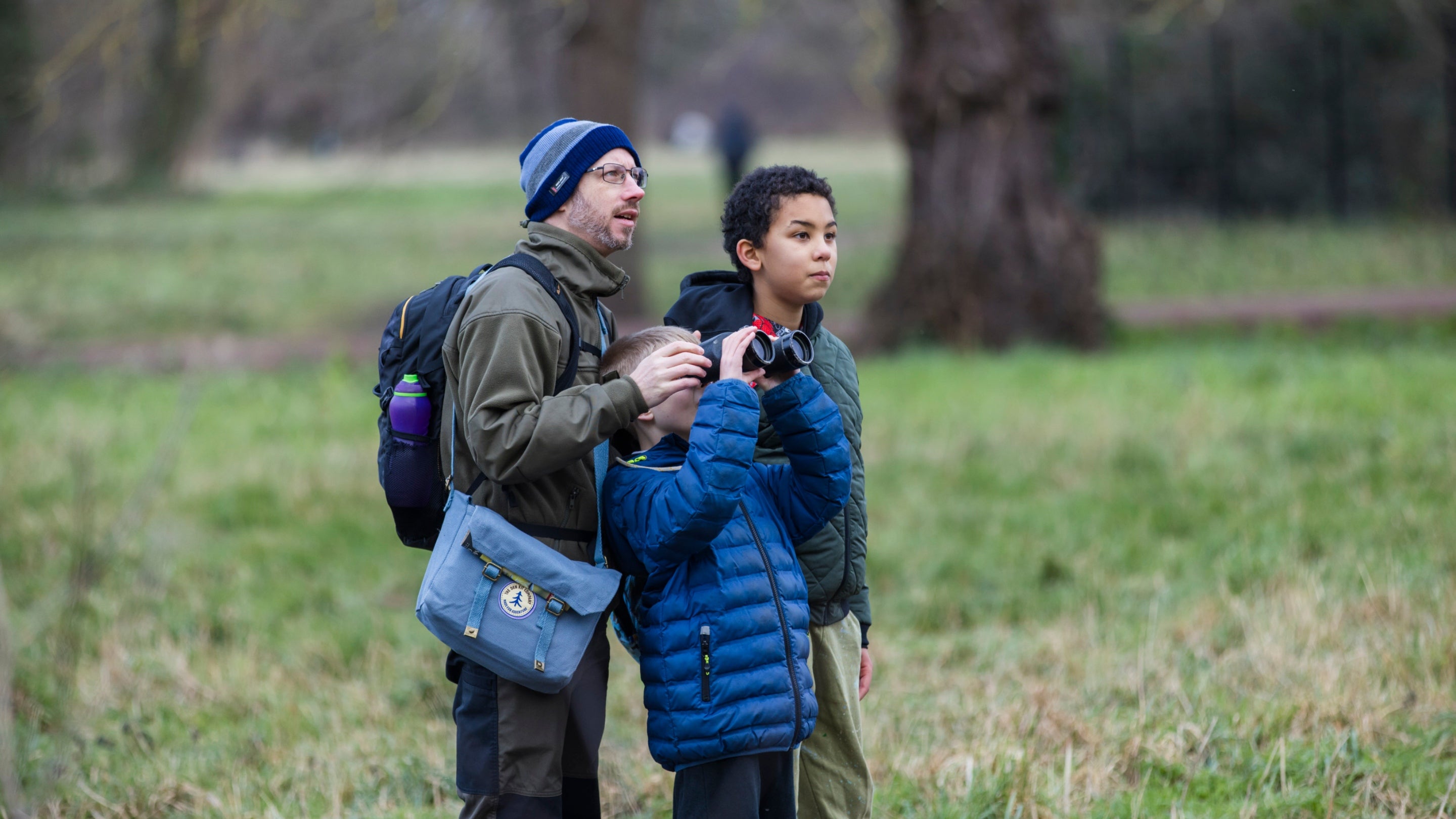 Visitors watch for birds through binoculars at Morden Hall Park, London