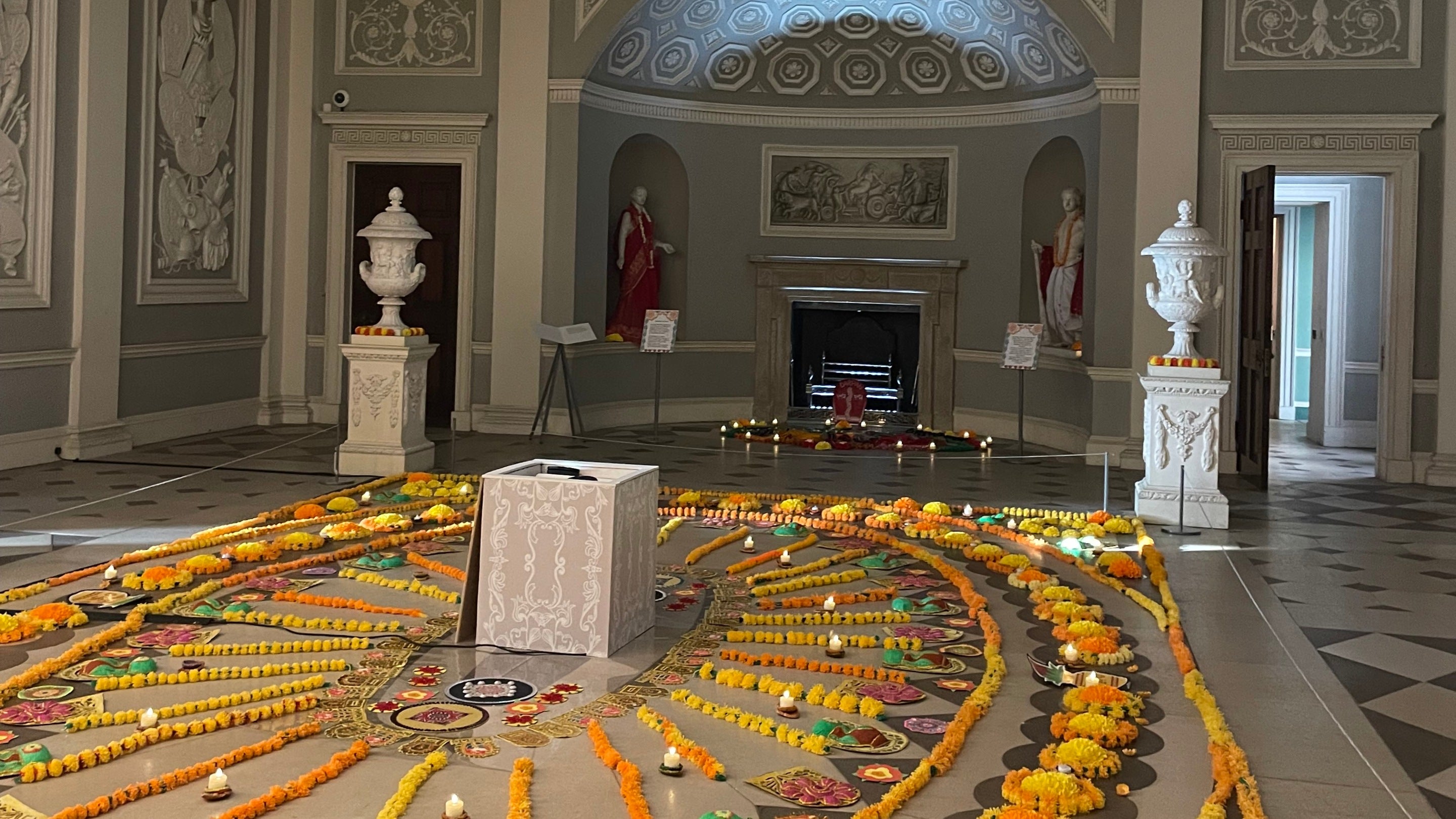 Diwali decorations in the Entrance Hall with statues in the background at the Marigold Festival 2025 at Osterley, London