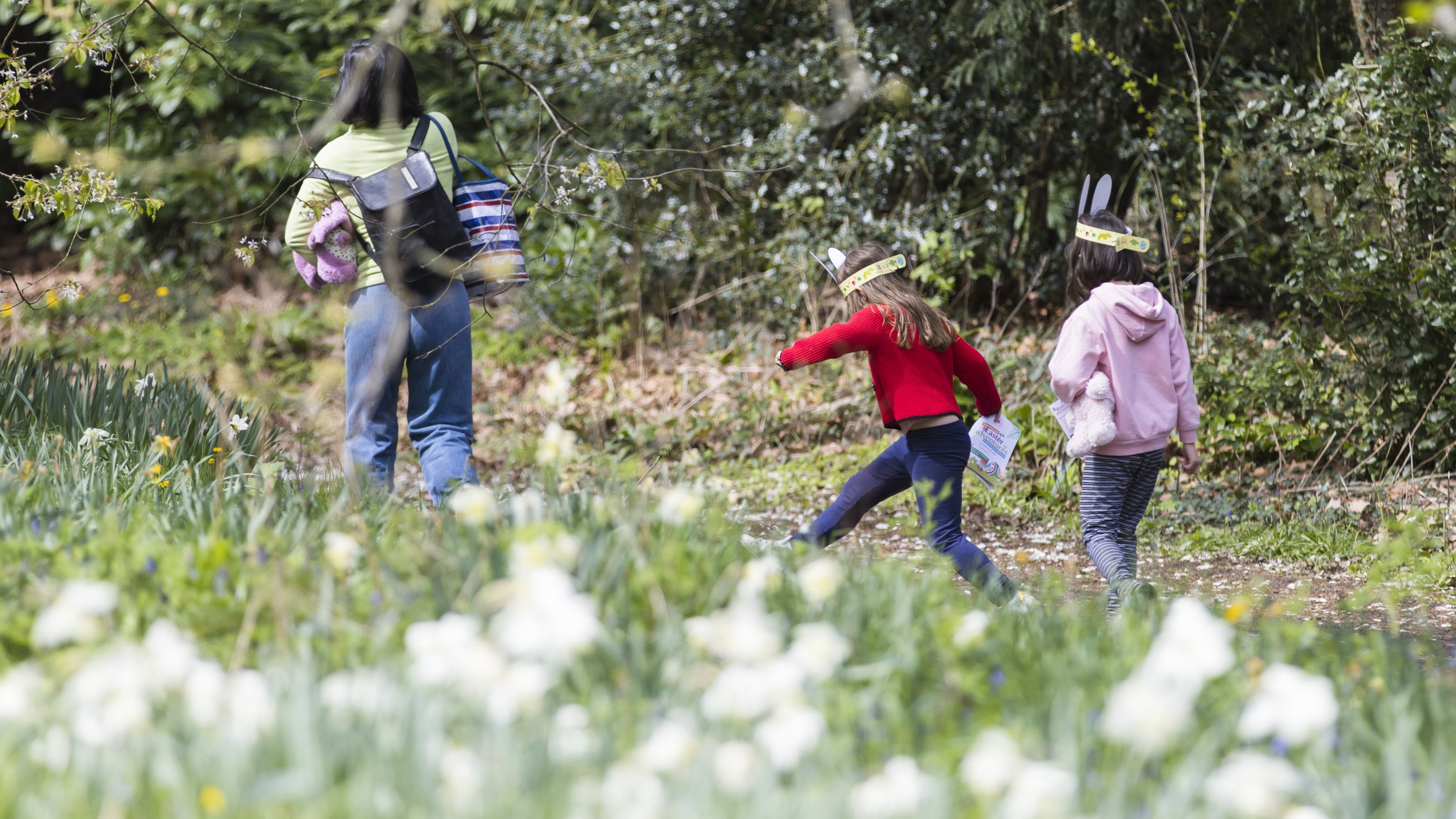 A family in the garden at Osterley against a foreground of white narcissi