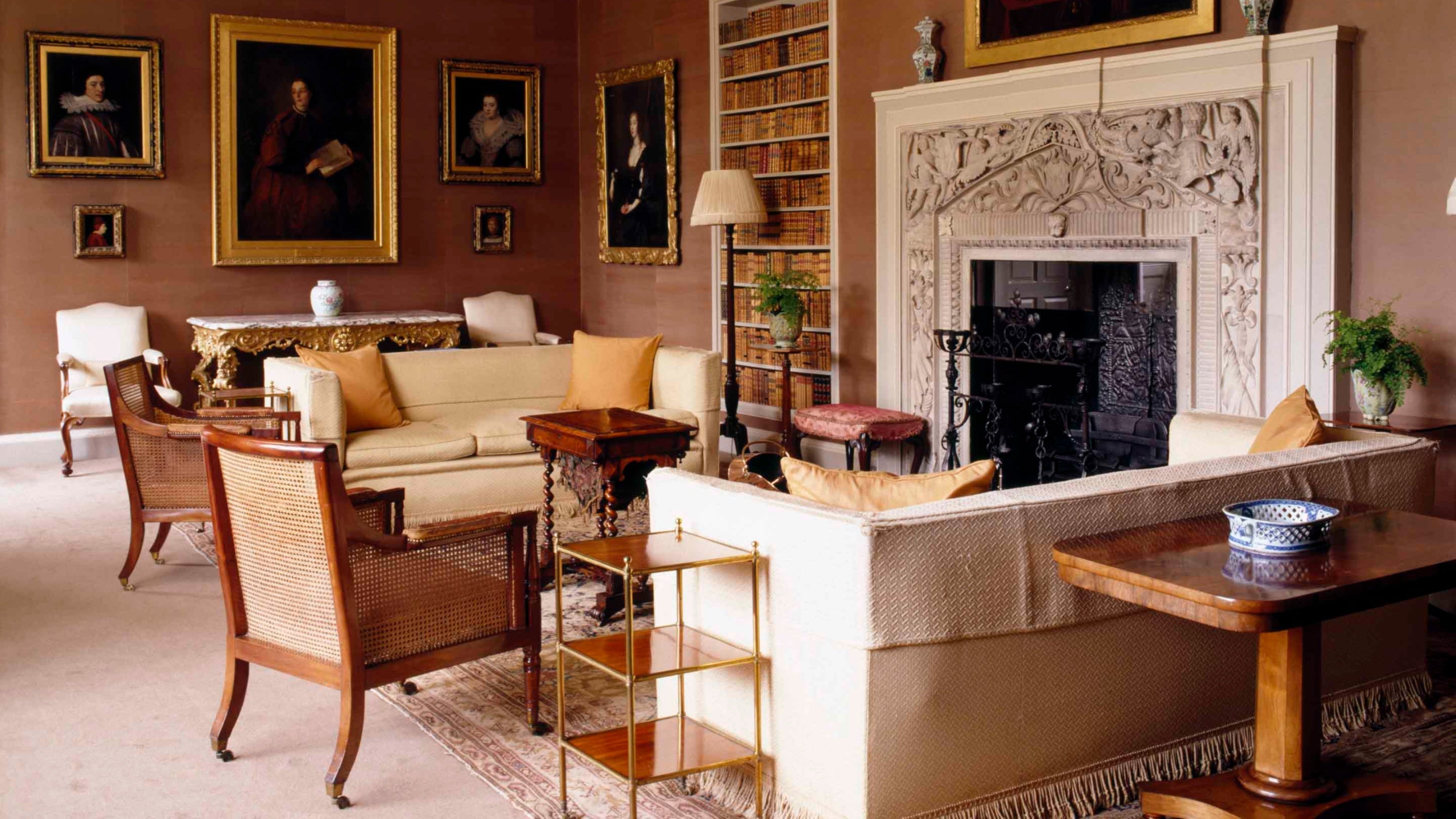The Brown Drawing Room at Blickling Hall, showing the fireplace with carved spandrels depicting angels c1400, thought to come from Sir John Fastolfe's Caister Castle, via the Oxted sale 1732