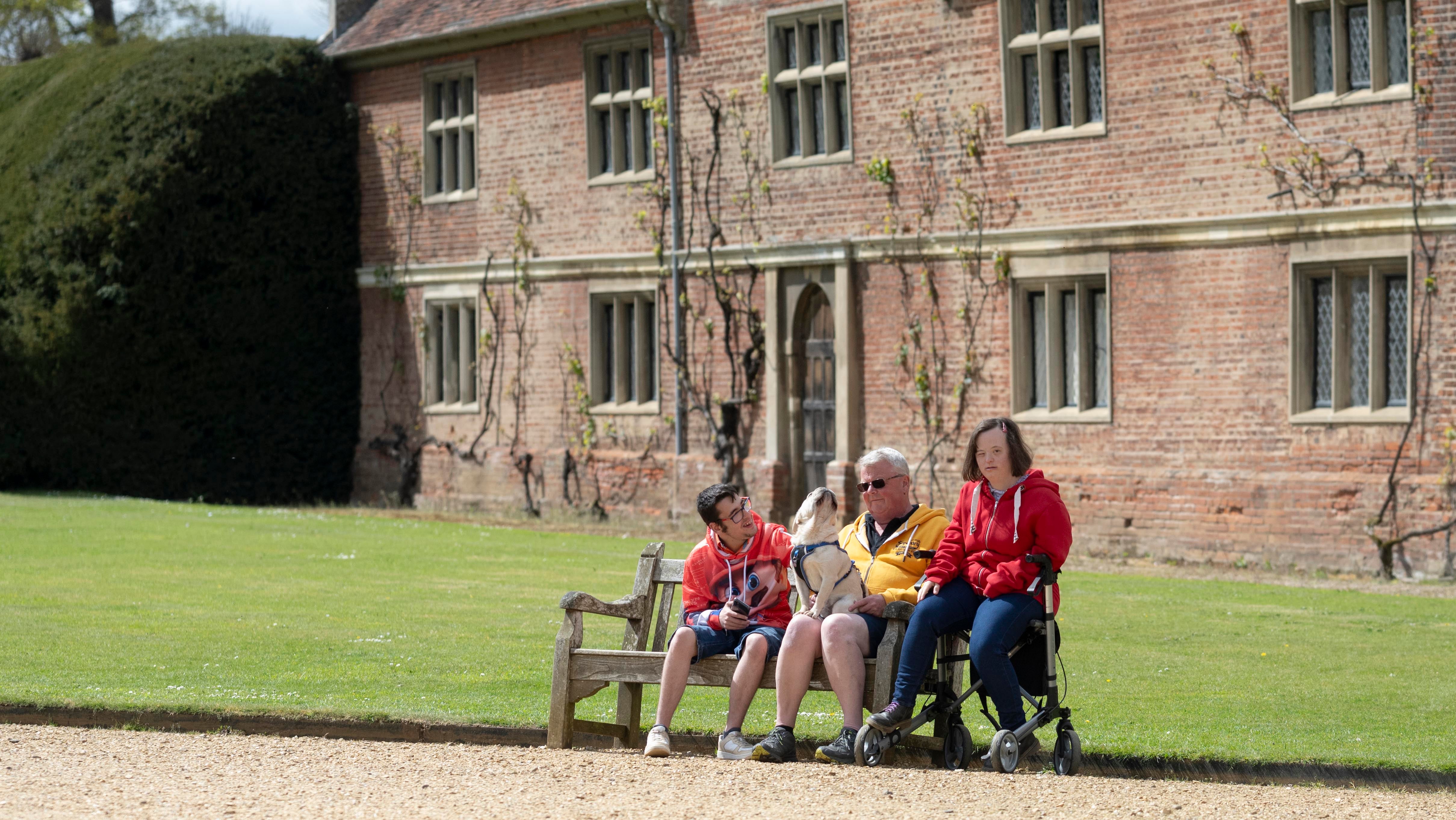 Visitors on a bench on the front drive at Blickling Estate