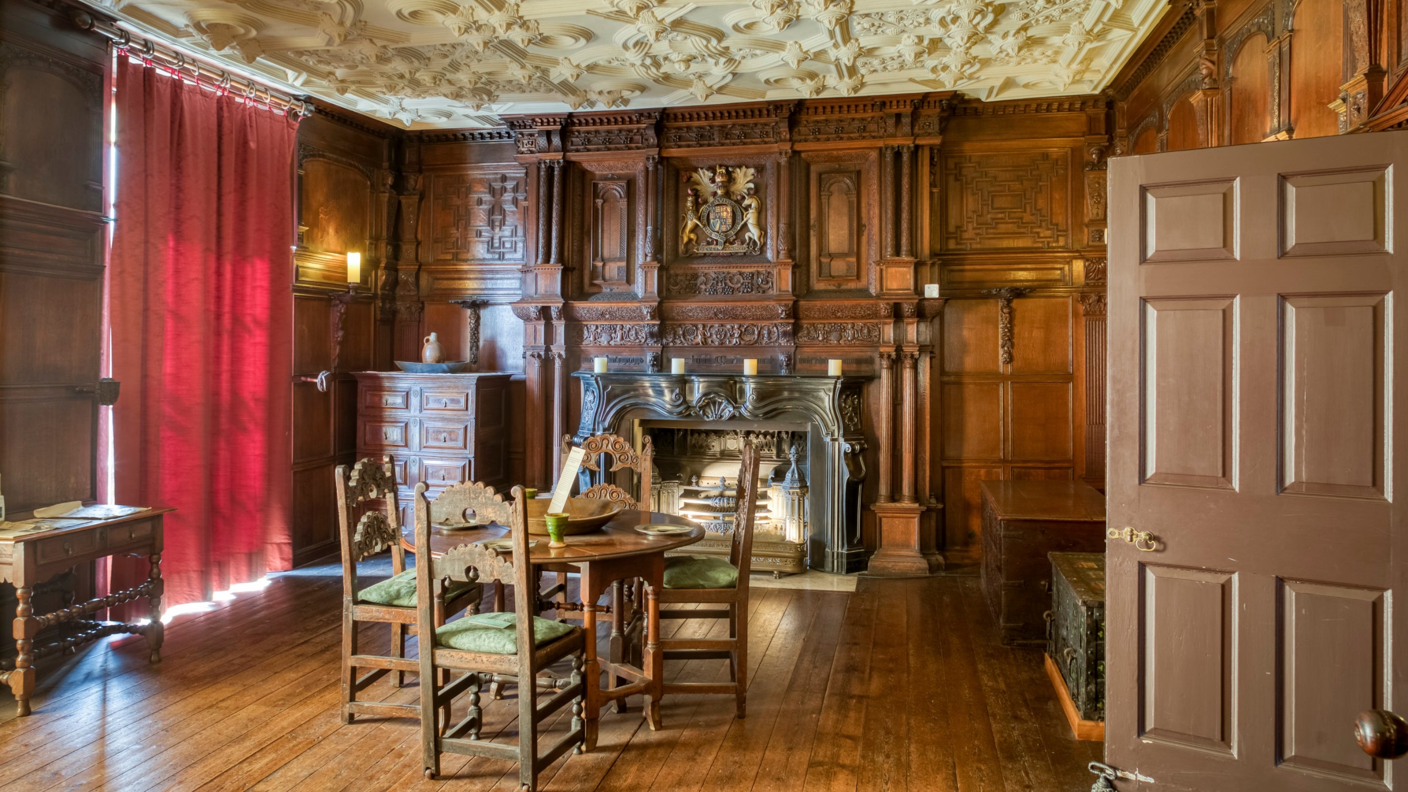 inside a dining room with wooden panelling, floor, table and four chairs at the Elizabethan House Museum