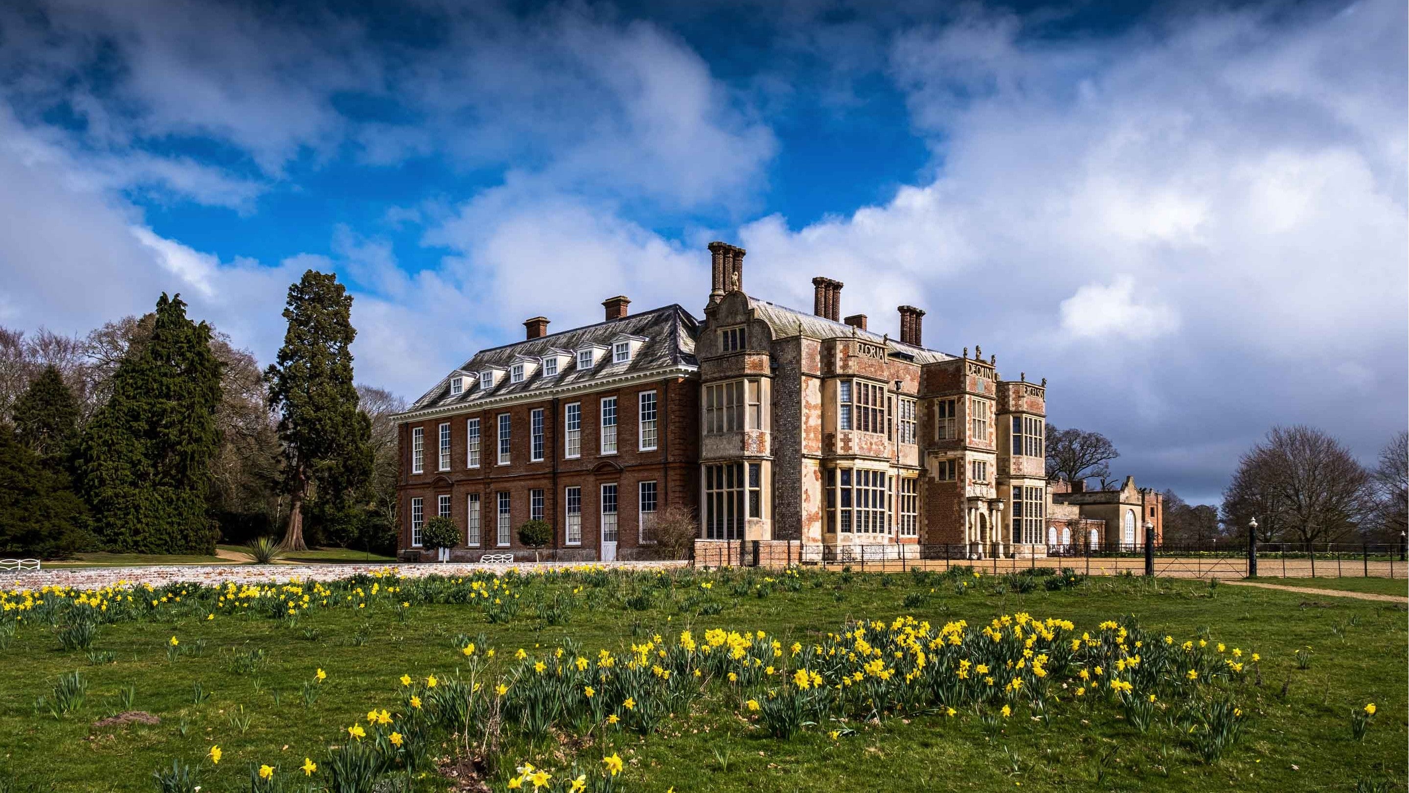 Felbrigg Hall, Norfolk in spring, behind daffodils in the parkland
