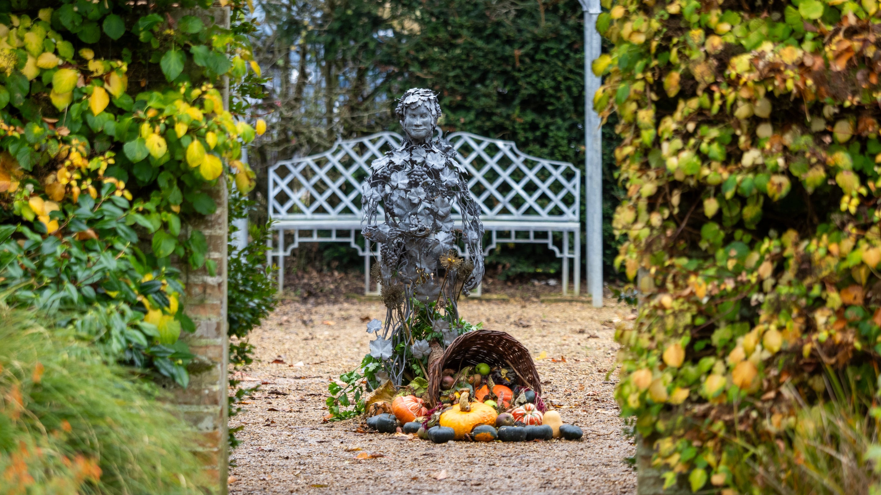 Toby Winterbourn's Bacchus Boy statue, scaled on artist's son, in Felbrigg's Walled Garden.