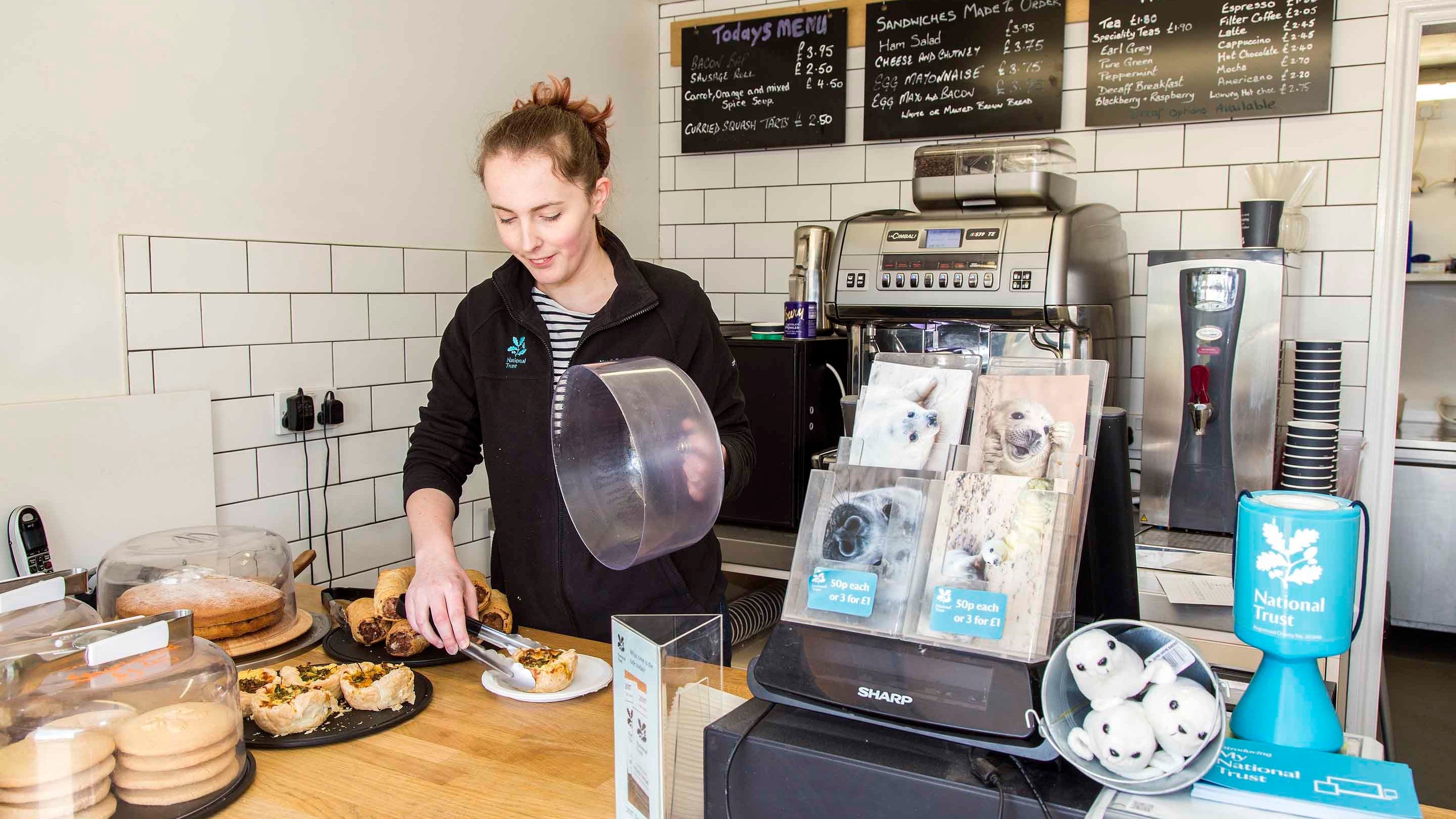 Staff member in the kiosk at Morston Quay, Blakeney National Nature Reserve, Norfolk.