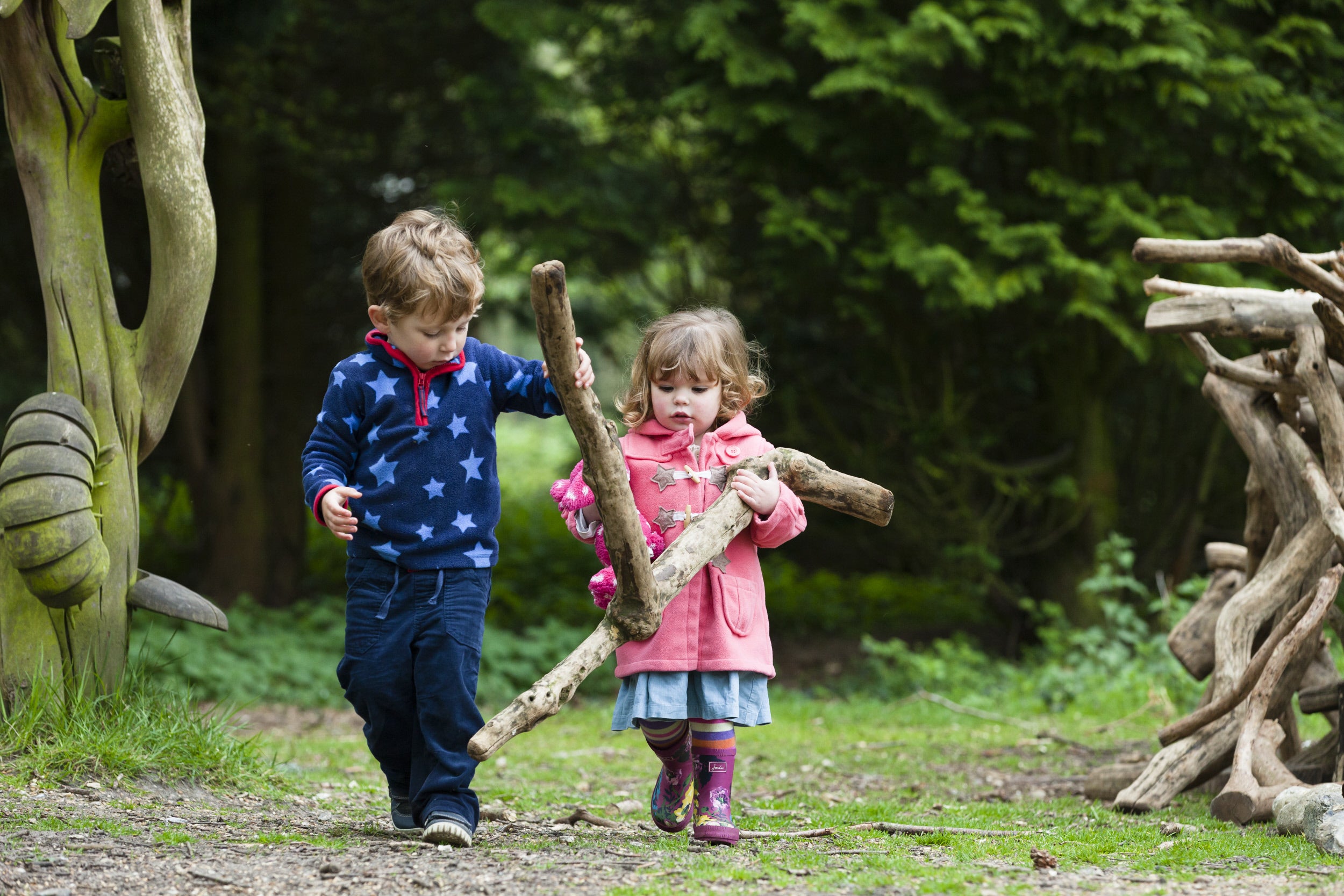 Two young children den building at Sheringham Park