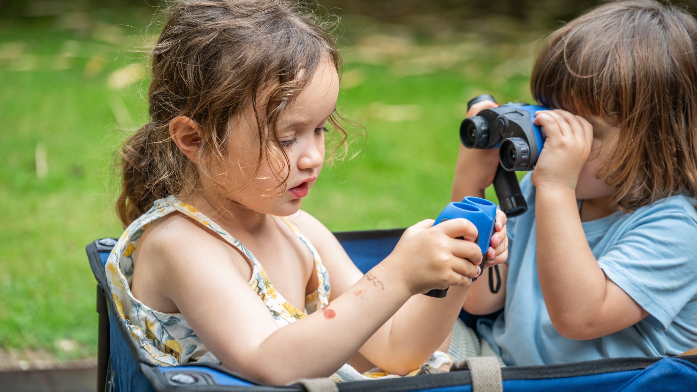 Children playing with binoculars as part of Summer of Play activities.