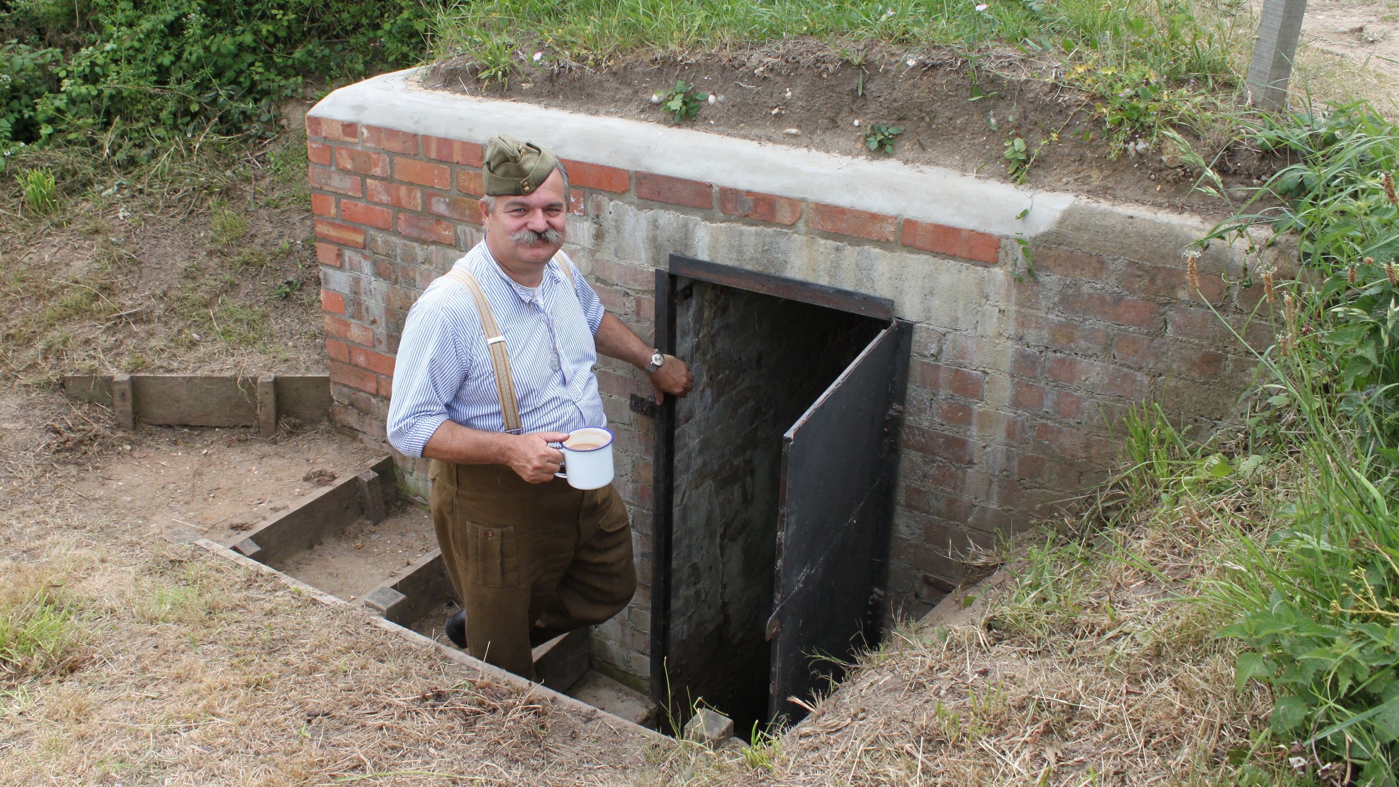 A solider in costume outside one of the pill boxes at Sheringham Park, Norfolk