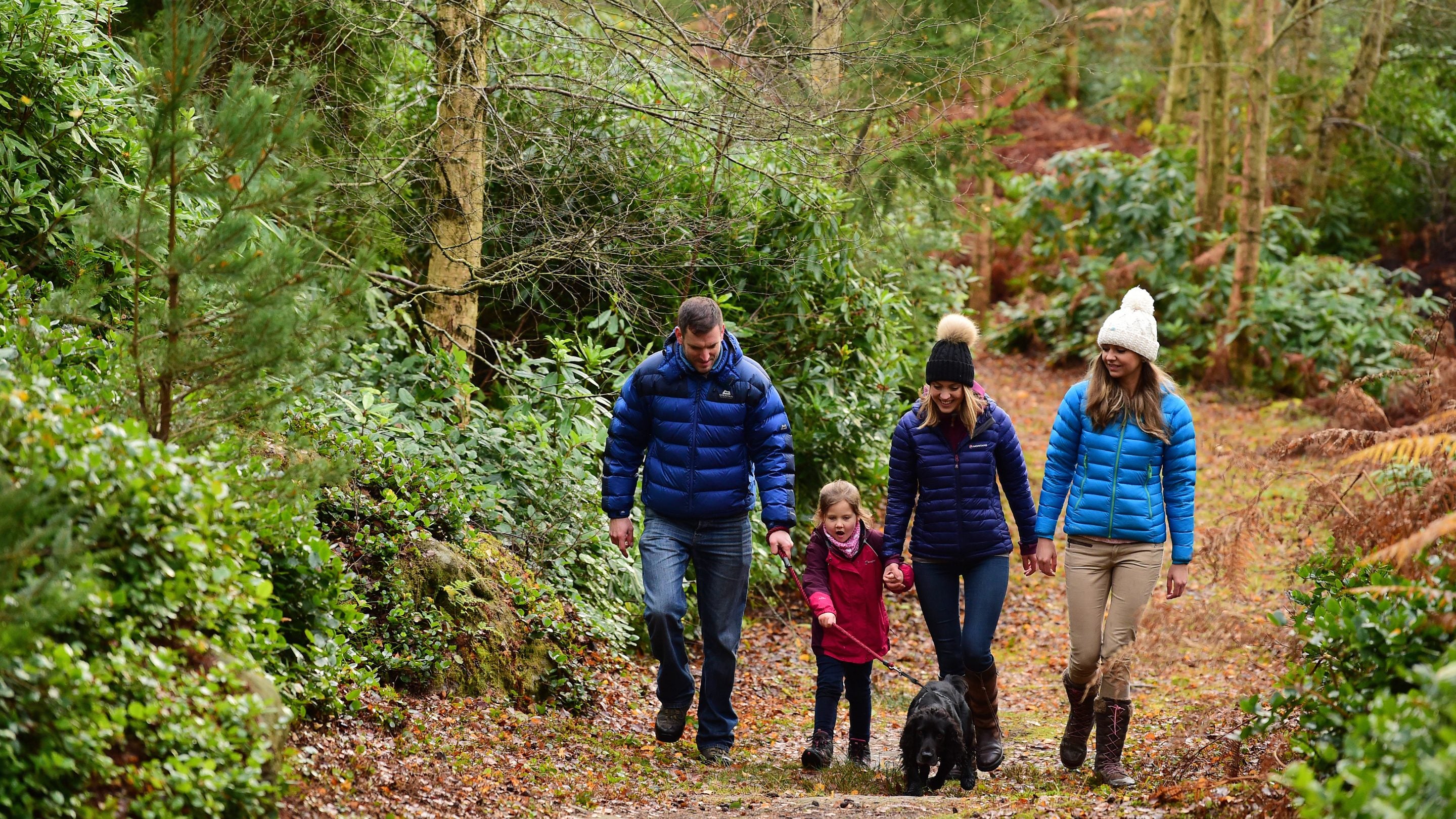 A family exploring the garden at Cragside, Northumberland,