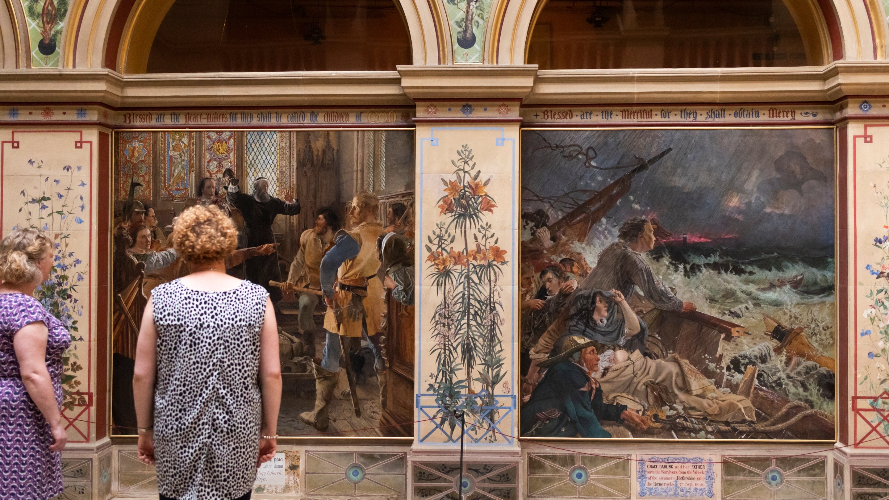 Visitors admiring paintings in the central hall at Wallington
