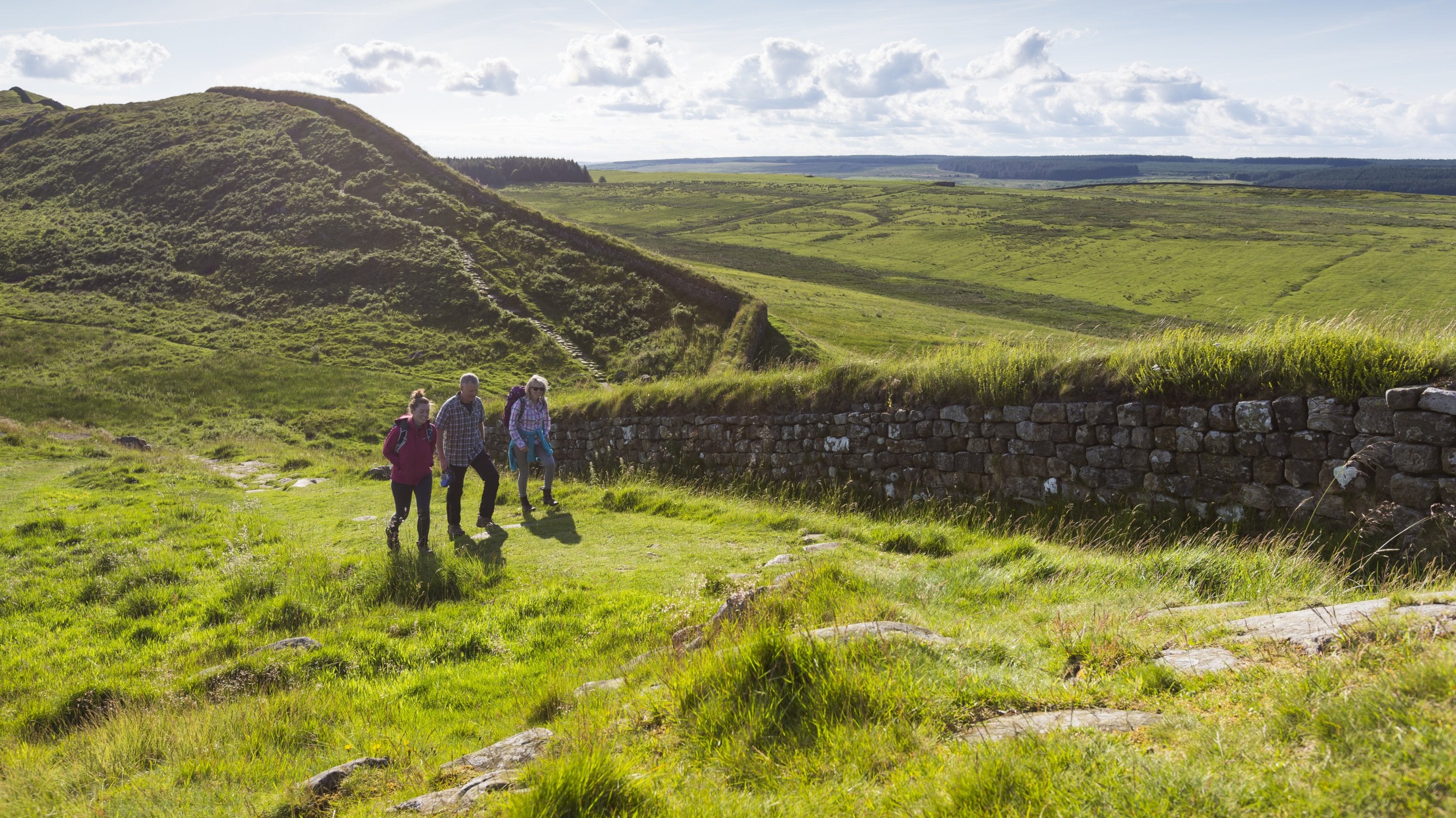 Visitors walking at Hadrian's Wall and Housesteads Fort, Northumberland