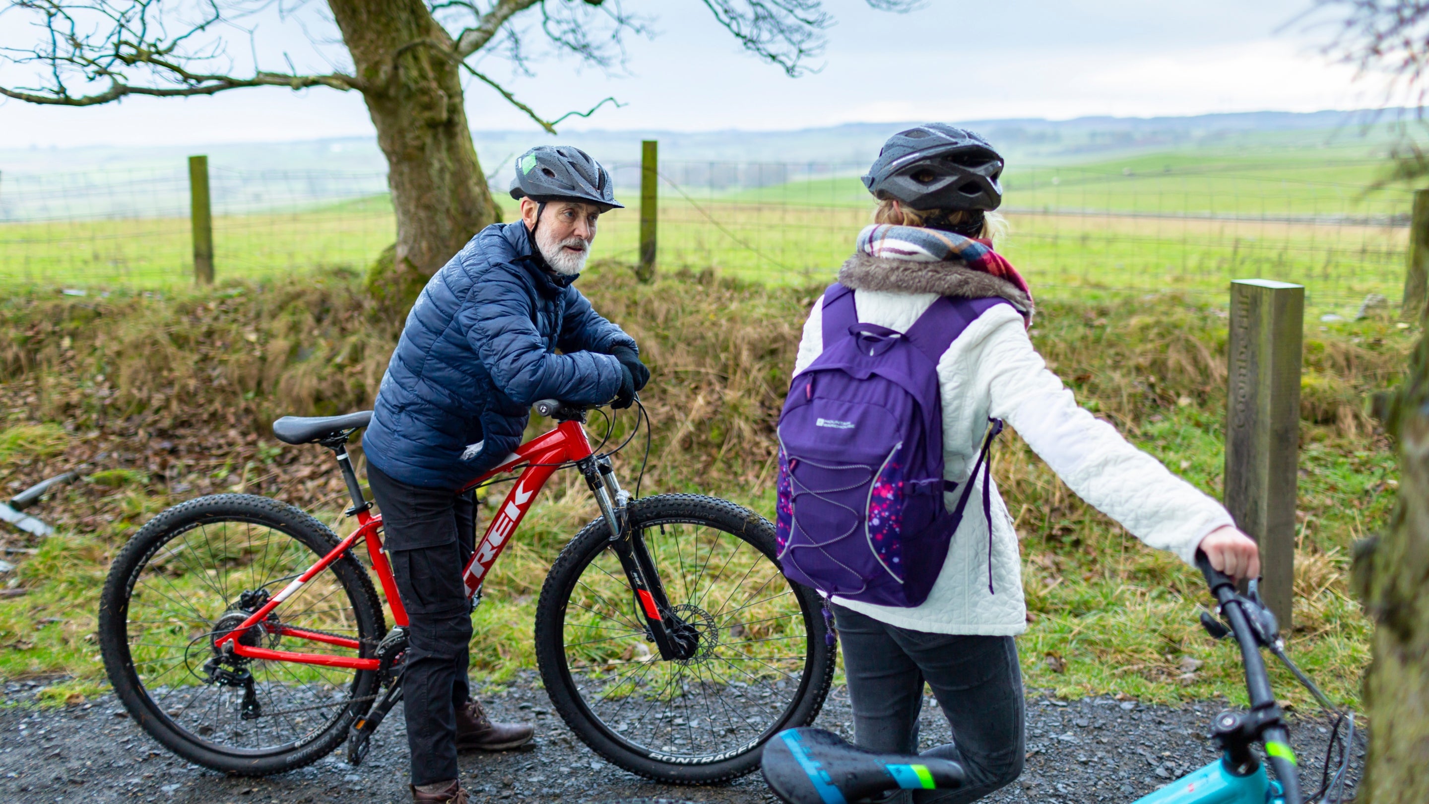 Two visitors with bikes on a trail around Wallington