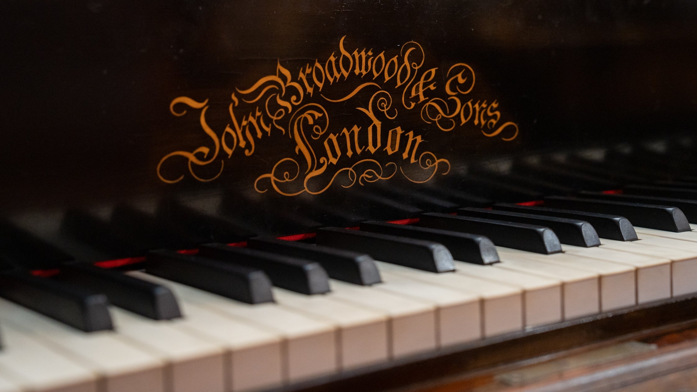 A detail shot of the Broadwood Piano & Sons London title above the keys on the piano at Cragside
