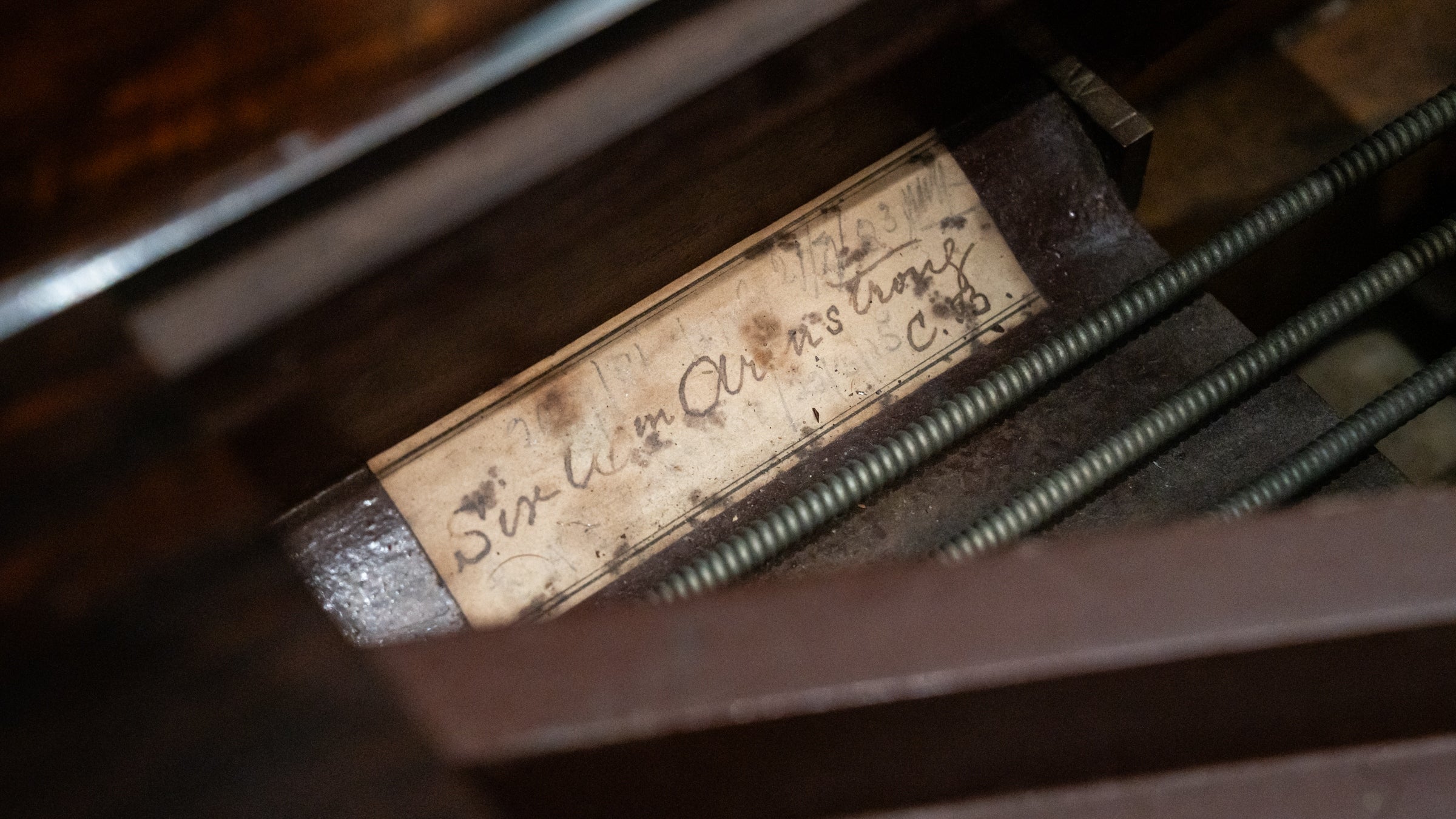 A label under the lid of Cragside's Broadwood Piano reading "Sir Wm. Armstrong".
