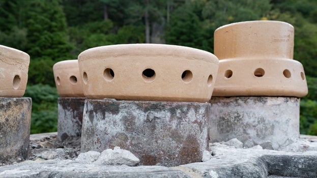 New peach coloured chimney toppers, similar to large upturned pepper-pots, place on top of Cragside's grand chimneys.